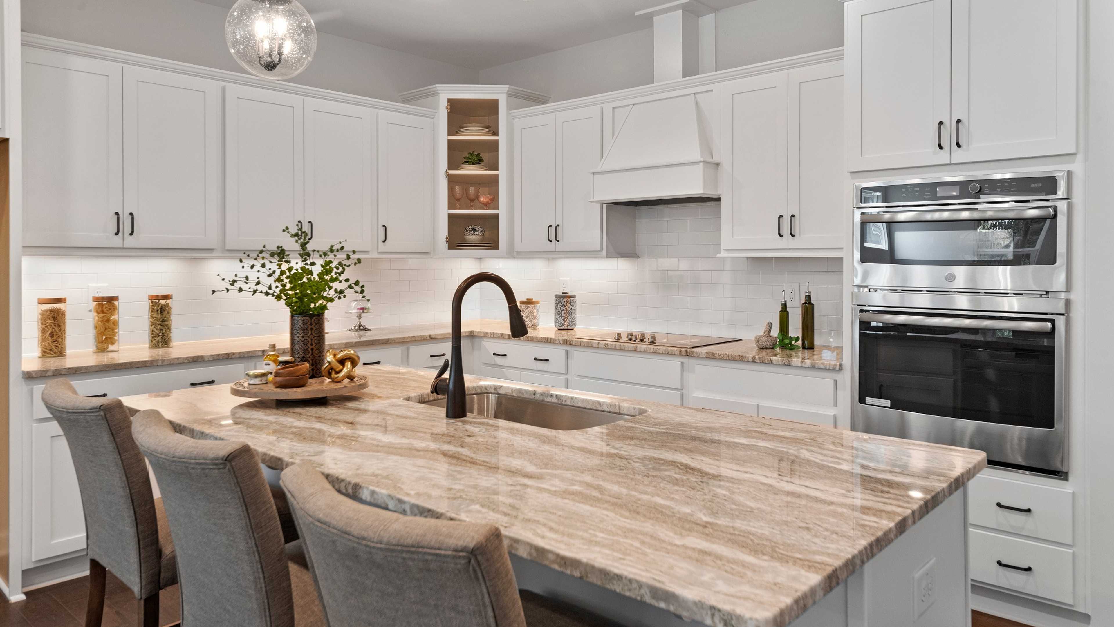 Davidson Homes Raleigh Division Kitchen with white cabinets and light brown marble countertops