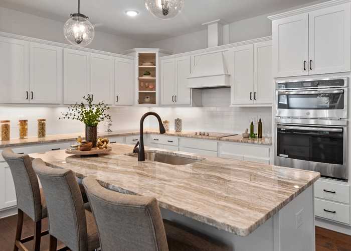 Davidson Homes Raleigh Division Kitchen with white cabinets and light brown marble countertops