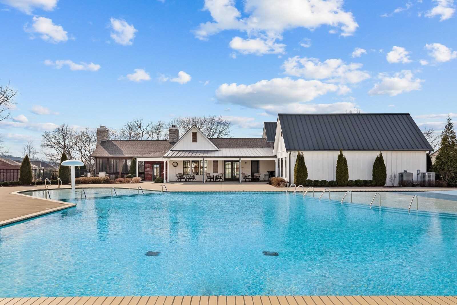 Community pool with lounge chairs and modern 2-story homes in Carellton, Gallatin, Tennessee by Davidson Homes