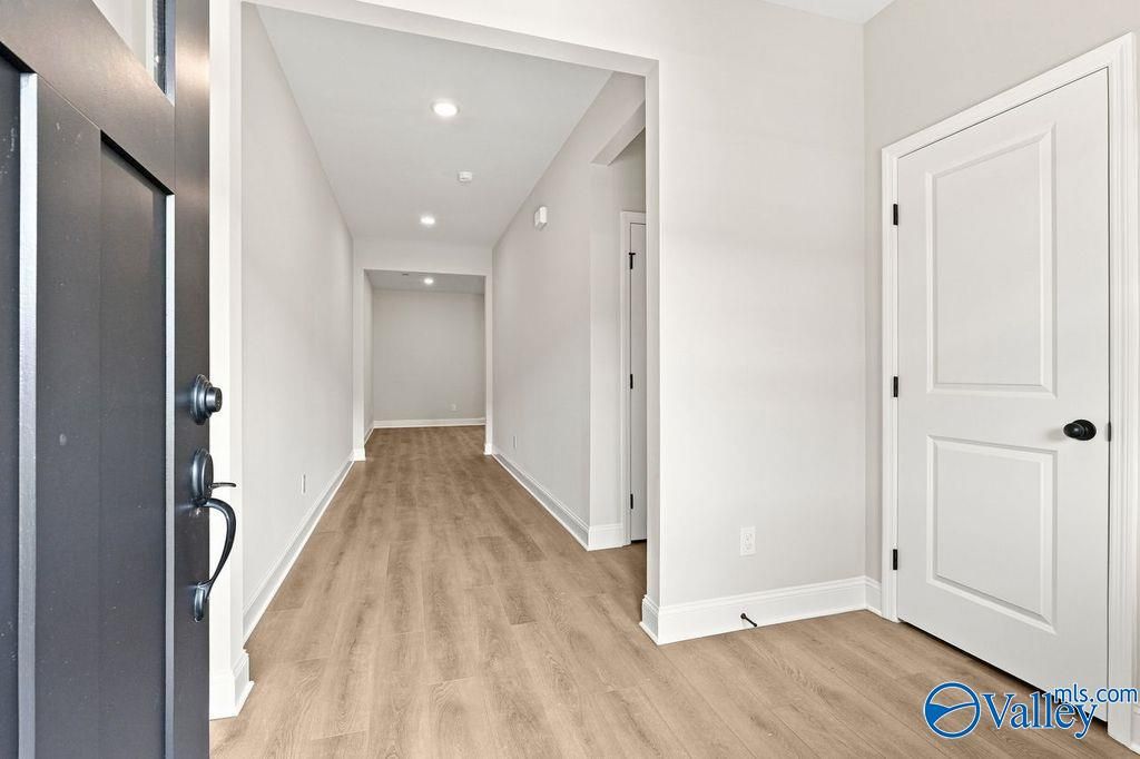 Bright, modern entryway with wood-look flooring inside The Camilla C floor plan at The Retreat at Cain Park in Hartselle.