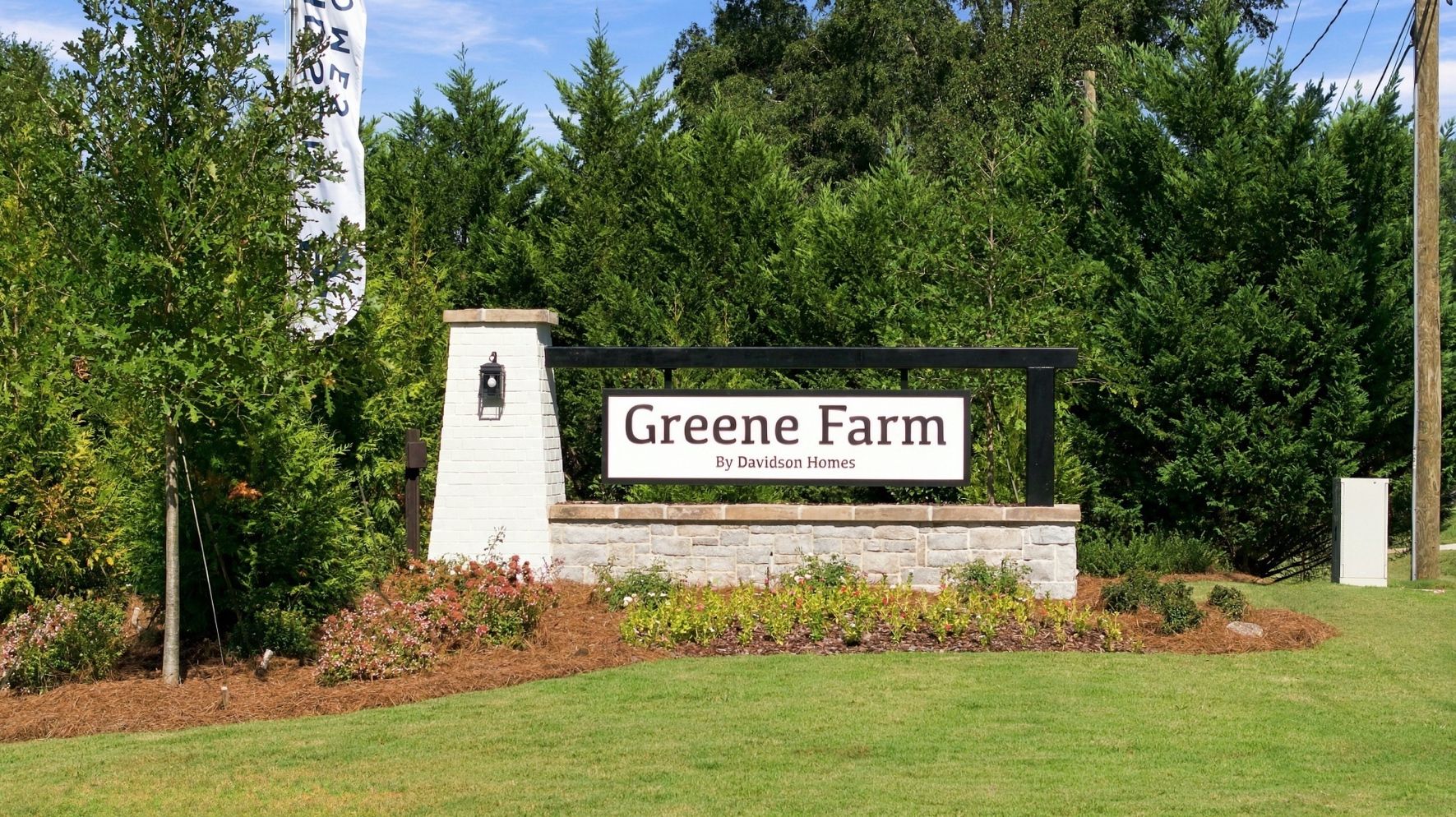 Greene Farm community entrance sign by Davidson Homes in Cartersville, Georgia with stone monument and landscaped flower beds