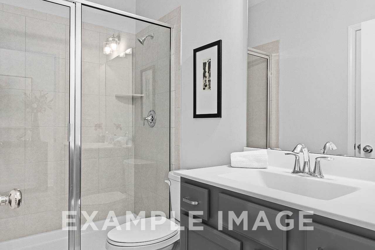 Davidson Homes the Chestnut Plan Guest Bathroom with toilet, single vanity and walk-in shower