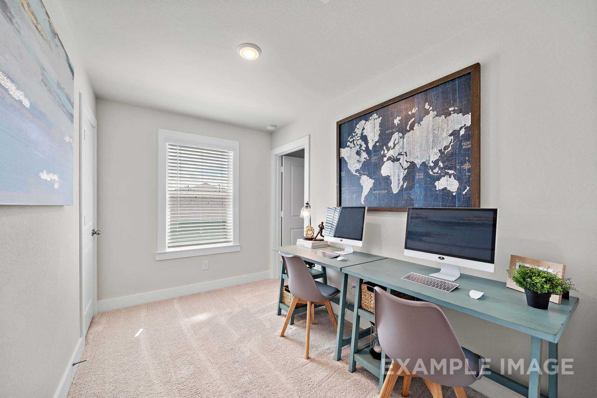 Cozy home office in The Lily A with dual turquoise desks, iMac monitors, world map art, and window view