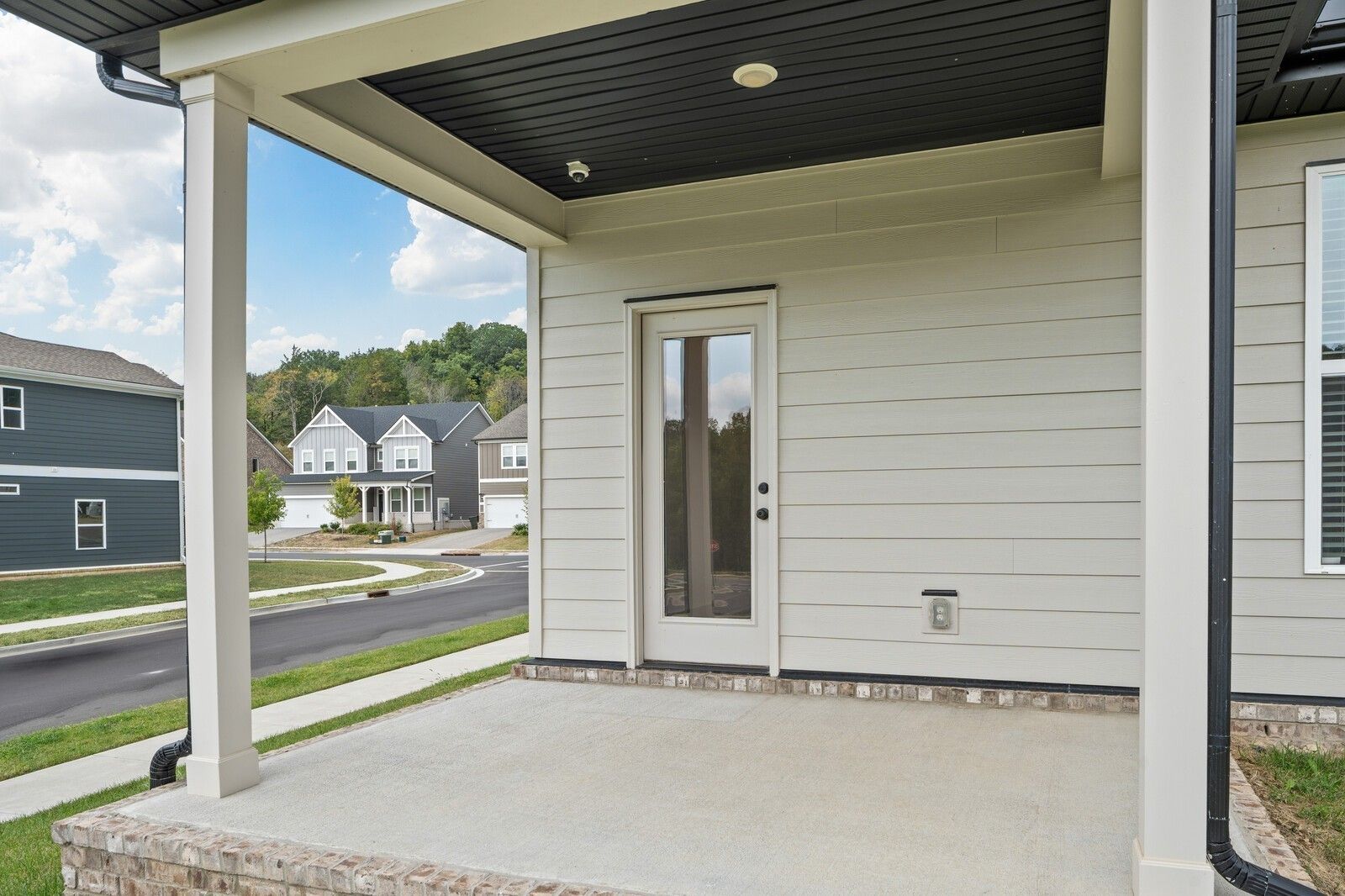 Covered front porch with glass door and black ceiling on Davidson Homes The Ridgeport in Carellton, Gallatin, Tennessee