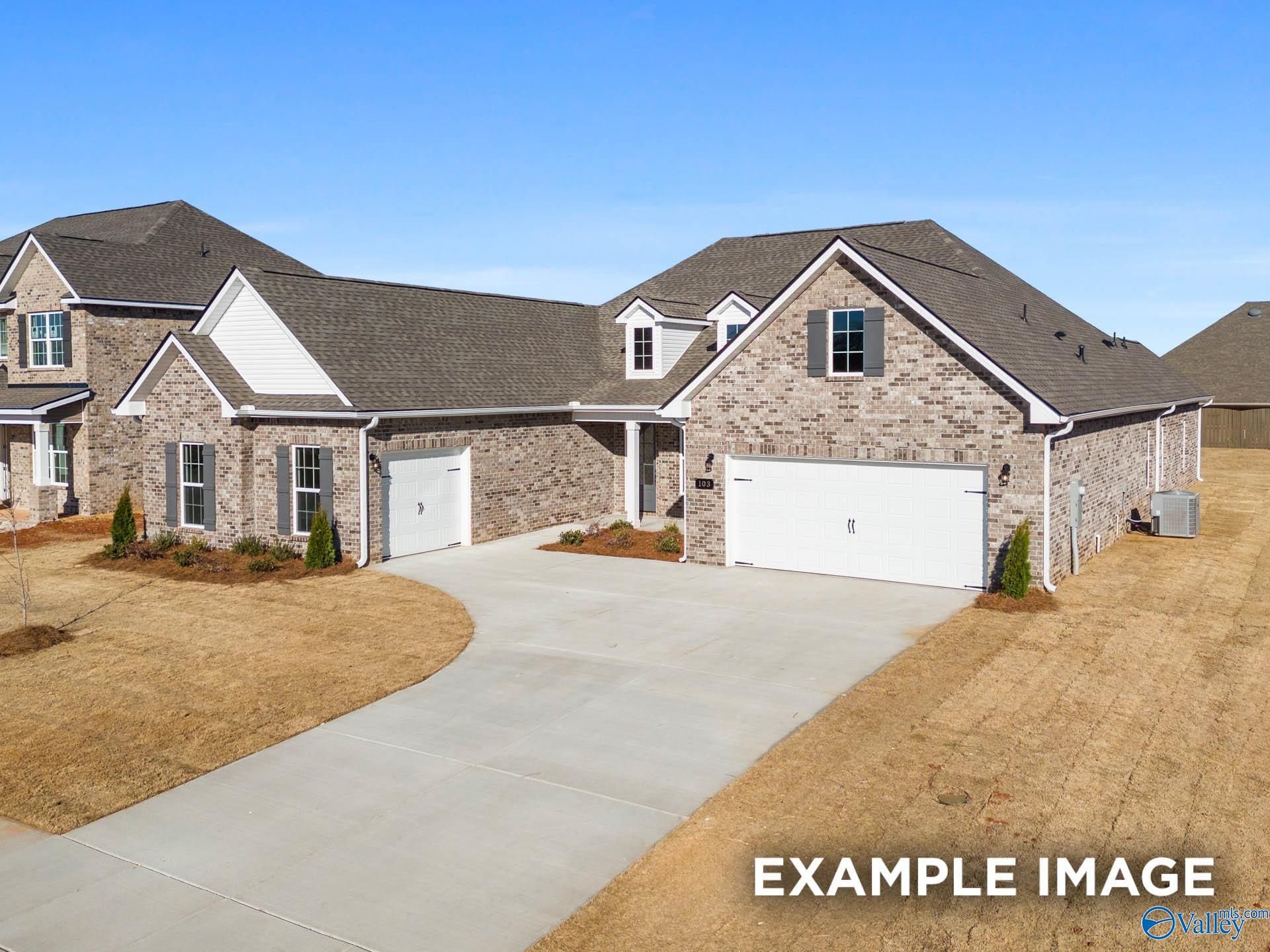 Modern 1-story brick home with 3-car garage, curved driveway, and landscaped yard in Briercreek, Meridianville, Alabama