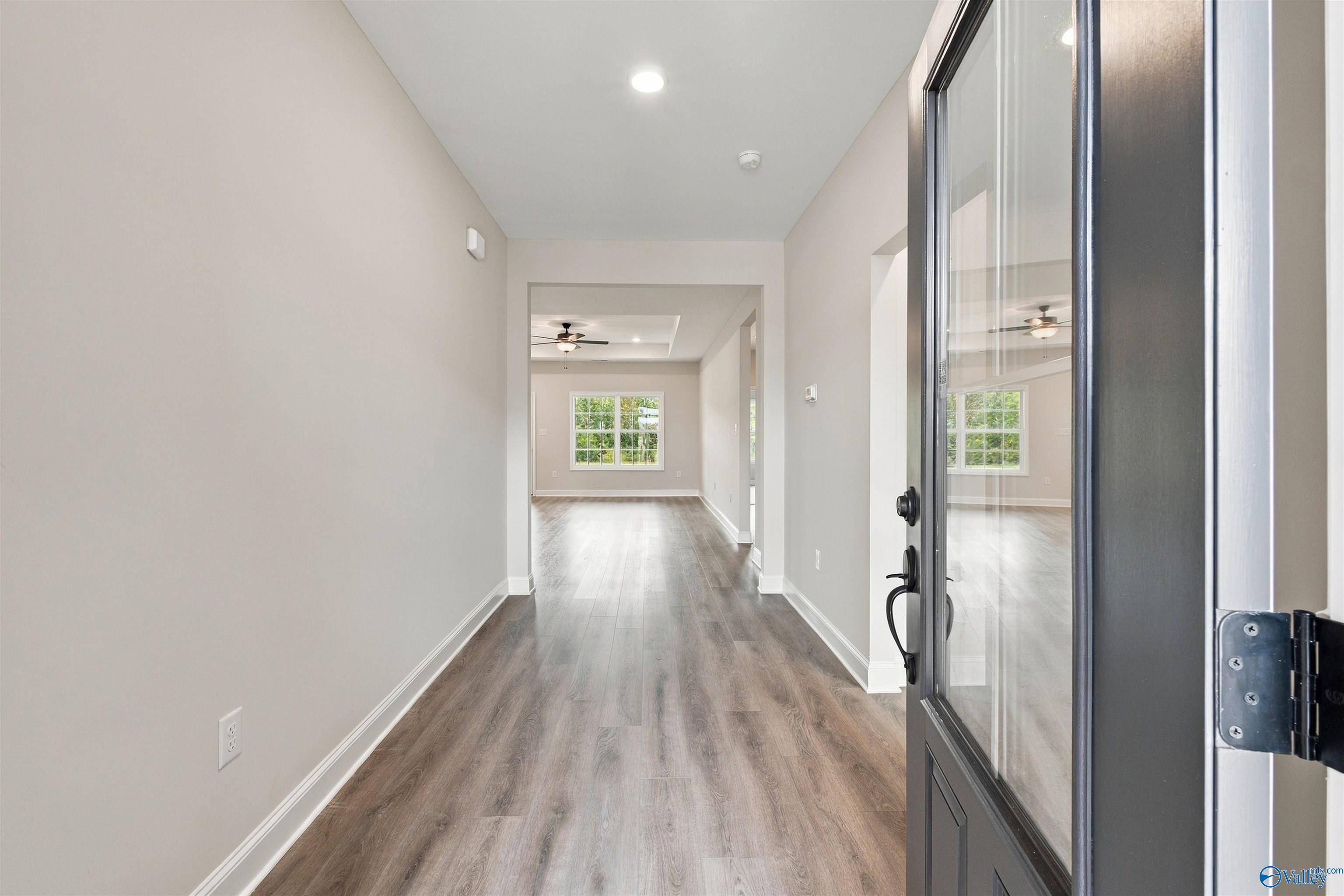 Foyer with luxury vinyl plank flooring and glass-panel front door in Davidson Homes The Montgomery, Decatur, Alabama