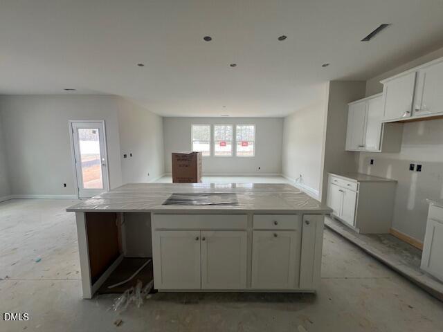 Open-concept kitchen with white cabinetry and large island in unfinished Davidson Homes Preston A, 4-bedroom Lillington NC home