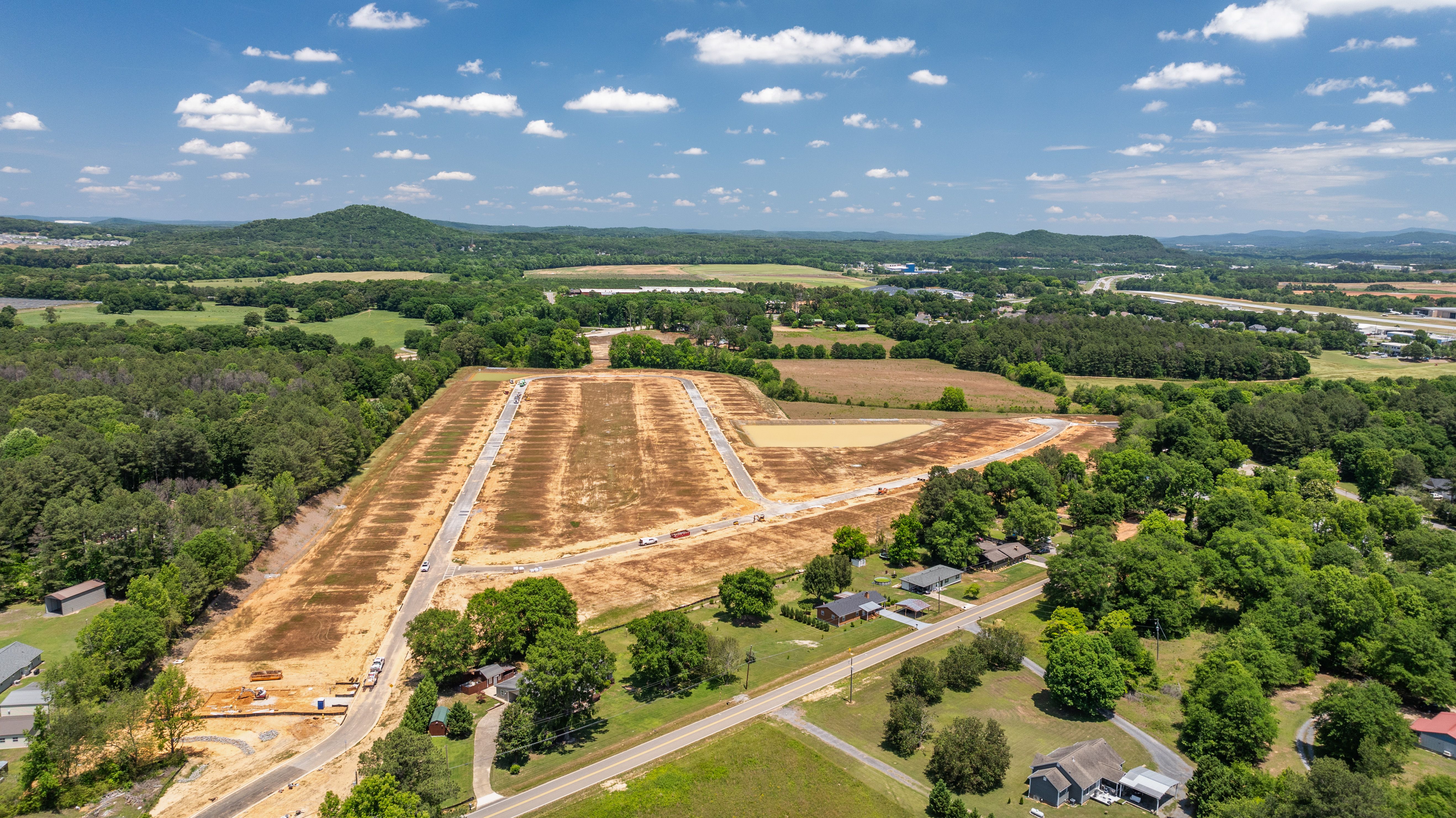 Aerial view of Greene Farm community land development in Cartersville, GA, featuring new roads by Davidson Homes.