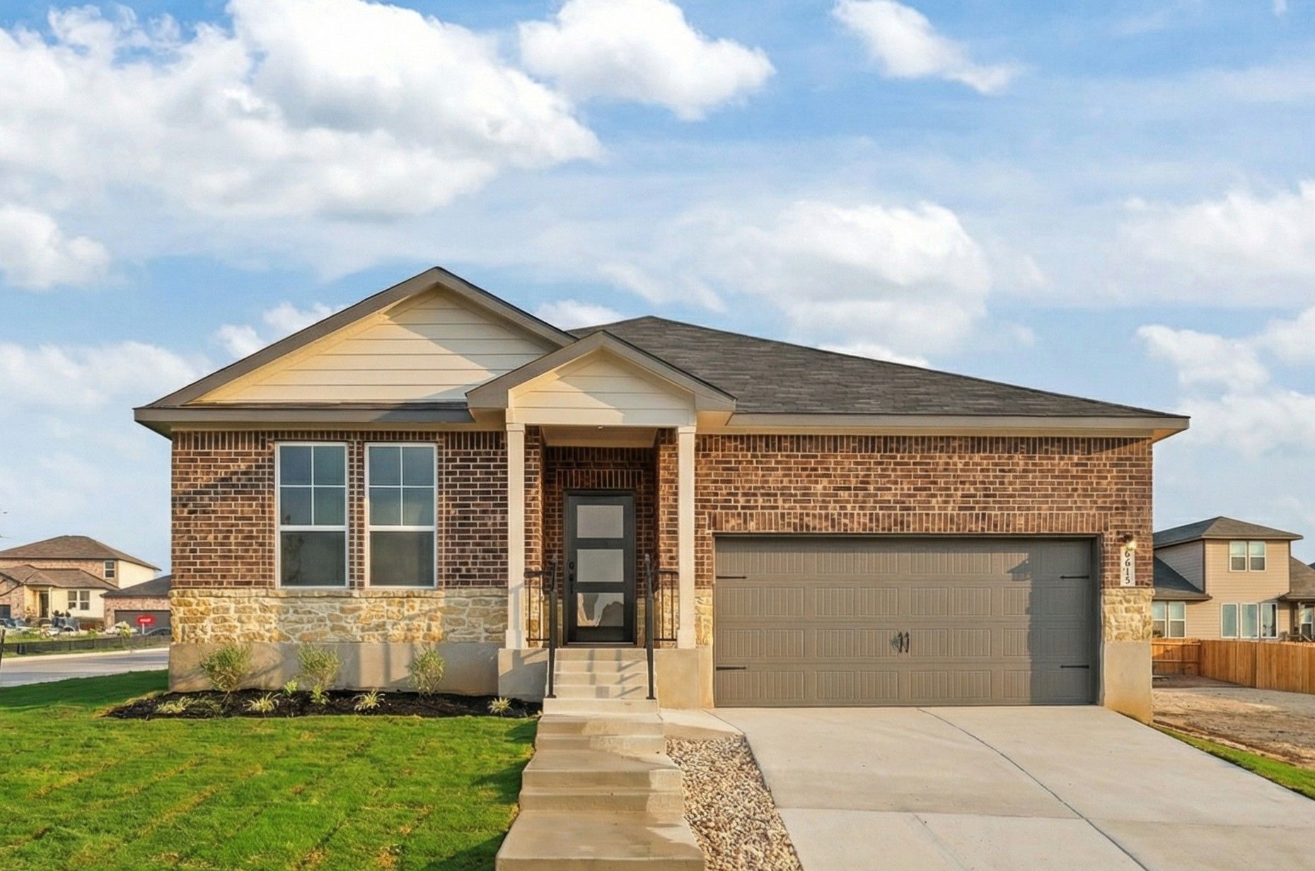 Brick ranch-style home exterior in Rayburn Valley, San Antonio TX with stone accents, covered porch, and attached garage