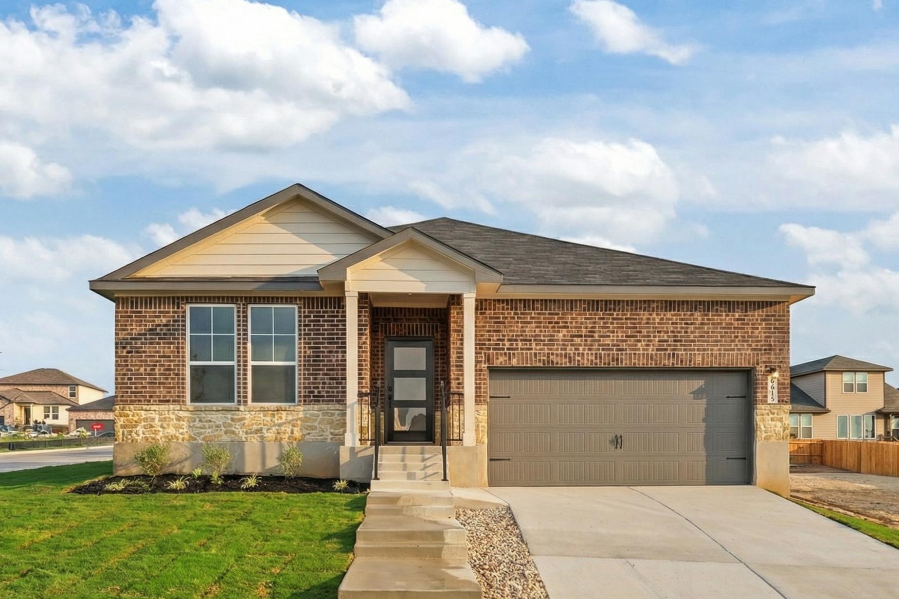 Brick ranch-style home exterior in Rayburn Valley, San Antonio TX with stone accents, covered porch, and attached garage