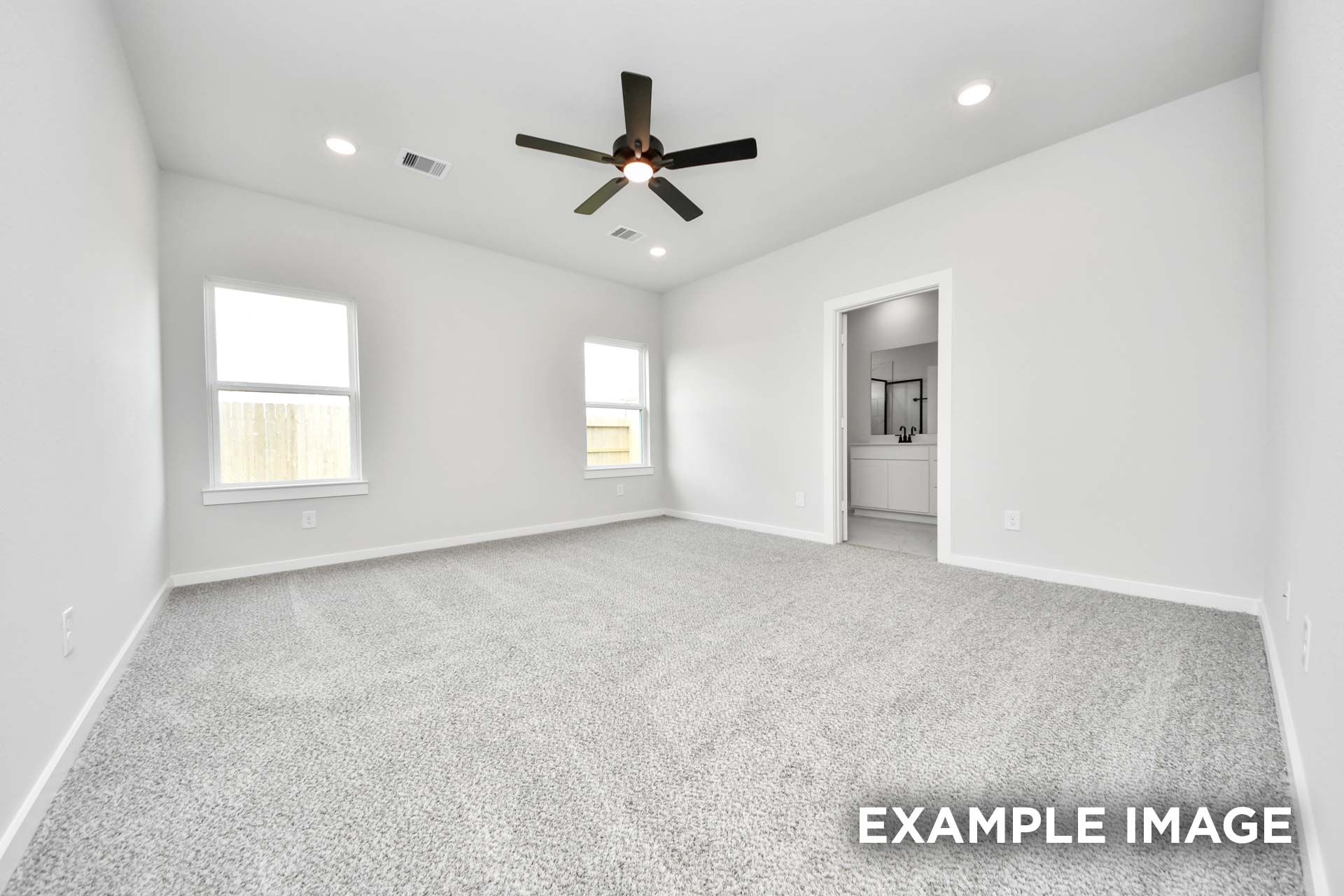 Spacious master suite with neutral carpet and ceiling fan in The Sorrento floor plan by Davidson Homes.