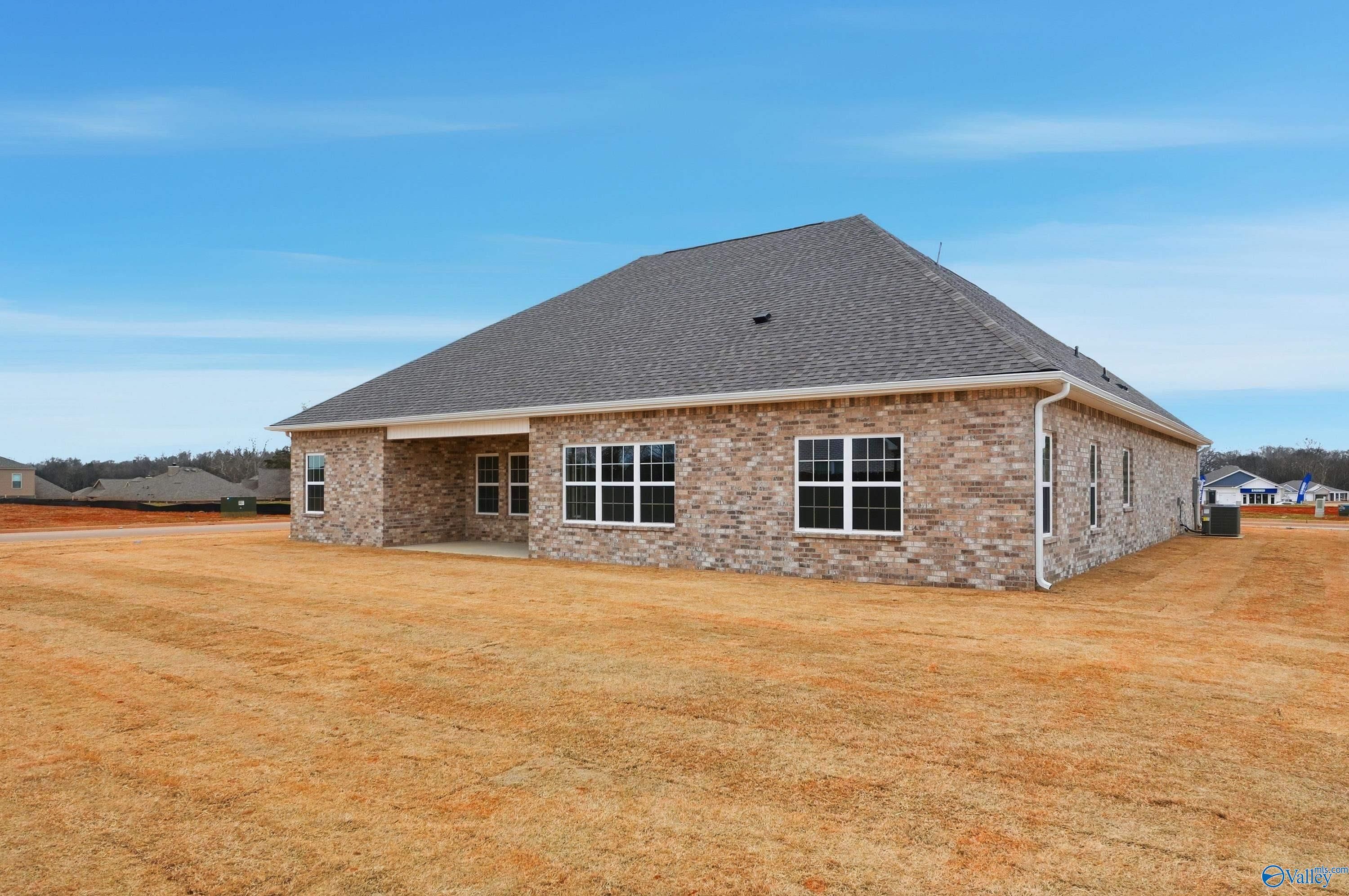 The Finleigh single-story brick home exterior with gabled roof, large windows, and covered patio in Briercreek, Meridianville, Alabama