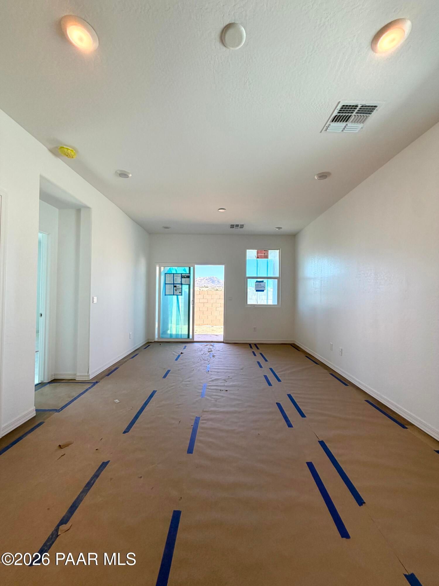 Spacious open living room with sliding glass door to backyard in Davidson Homes Marietta C plan, Prescott, Arizona