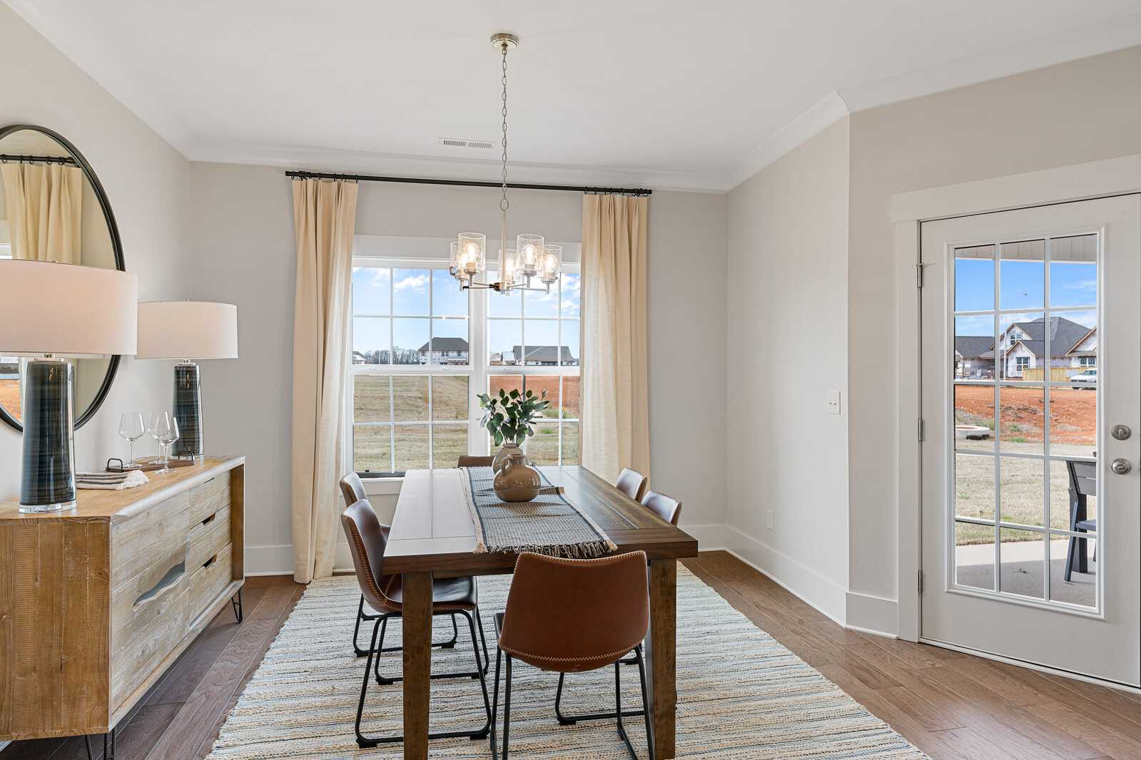 Decorated dining area with a dining table, chairs, and overhead lighting