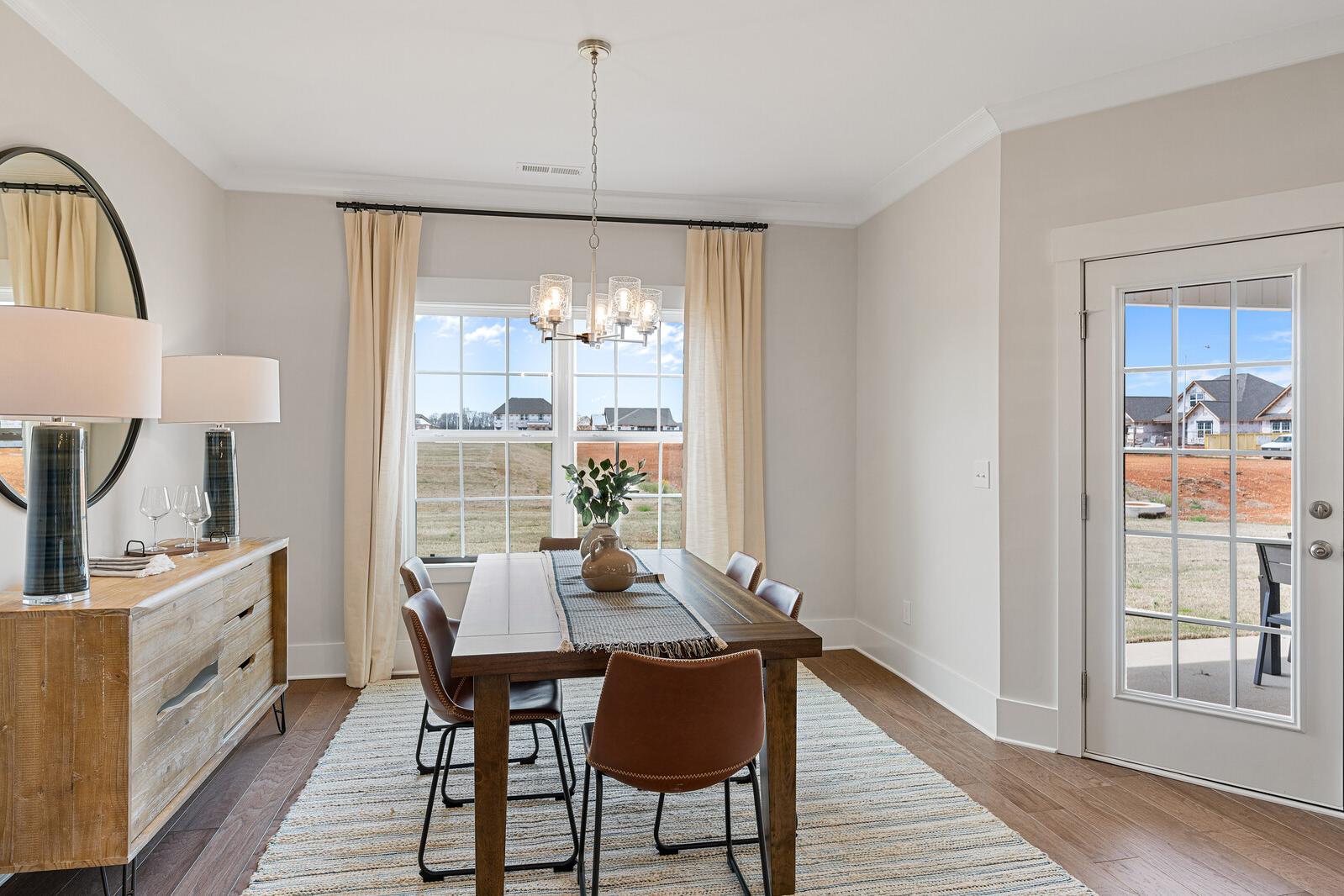 Decorated dining area with a dining table, chairs, and overhead lighting