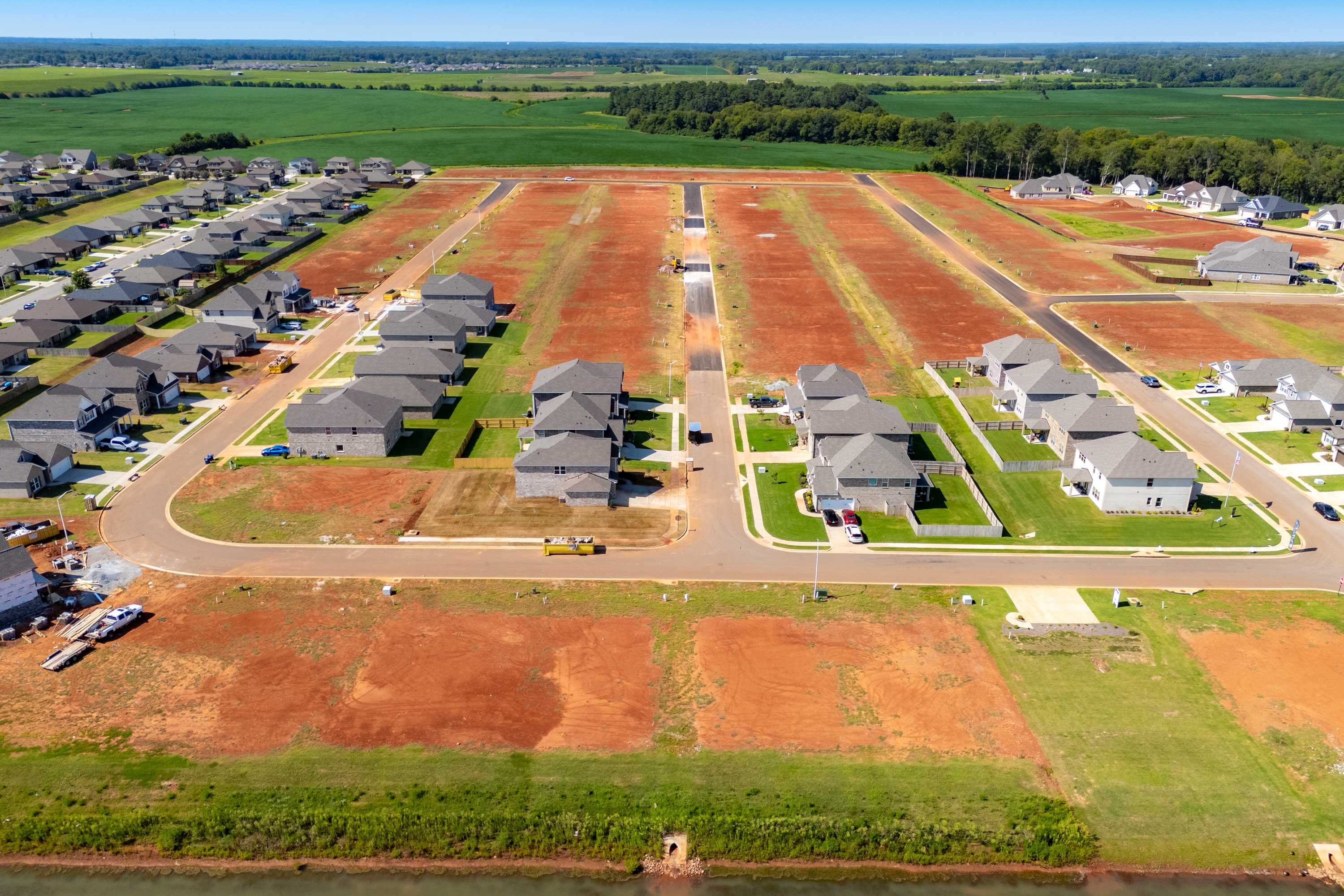 Aerial view of Walker's Hill neighborhood in Meridianville AL with new Davidson Homes, red clay lots, and surrounding farmlands