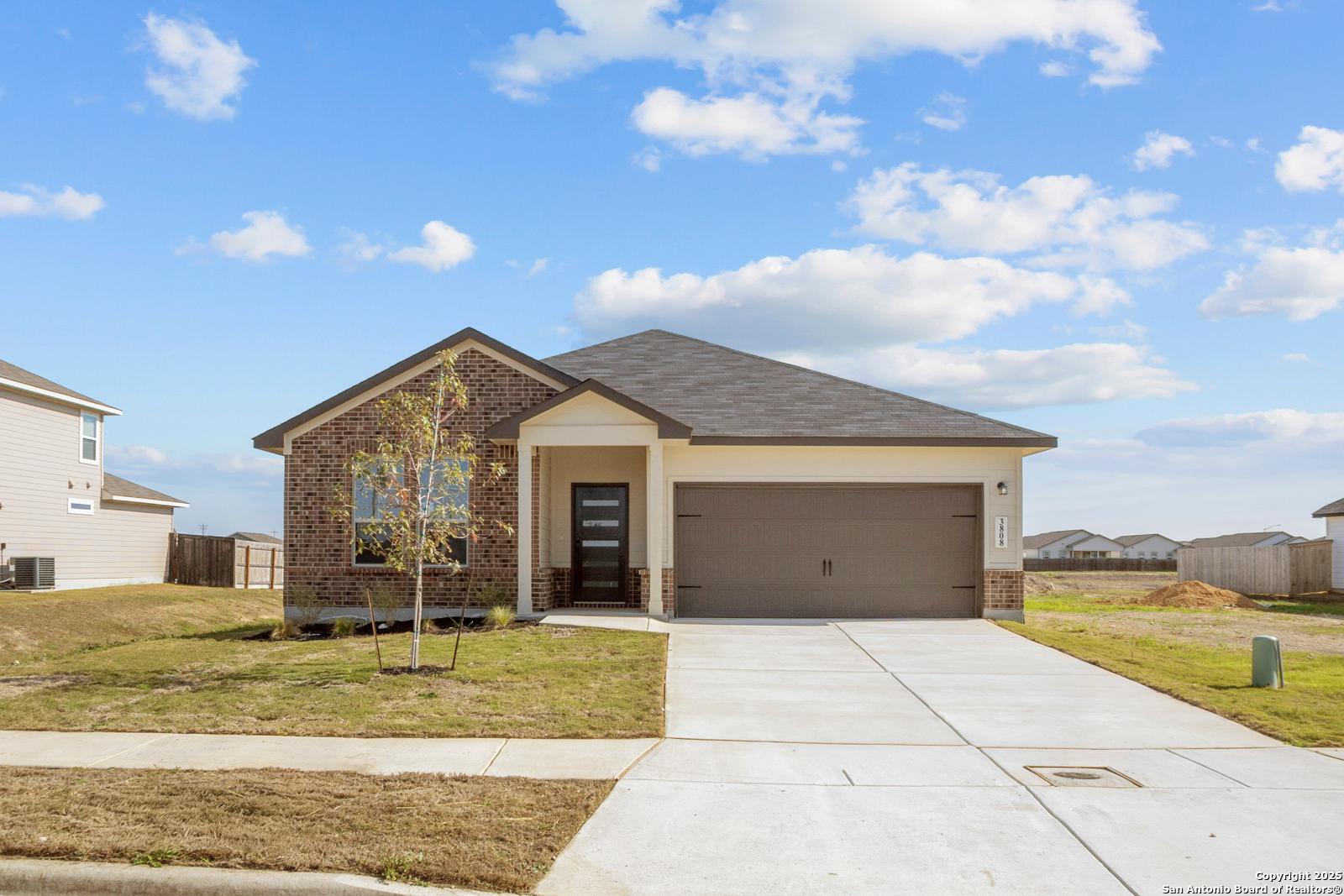 Modern single-story brick home with 2-car garage and front porch in Hannah Heights, Seguin, Texas - The Daphne H by Davidson Homes