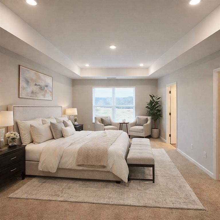 Elegant master bedroom with king bed, beige walls, accent chairs, and potted plant in The Wake E plan, Cumming, GA