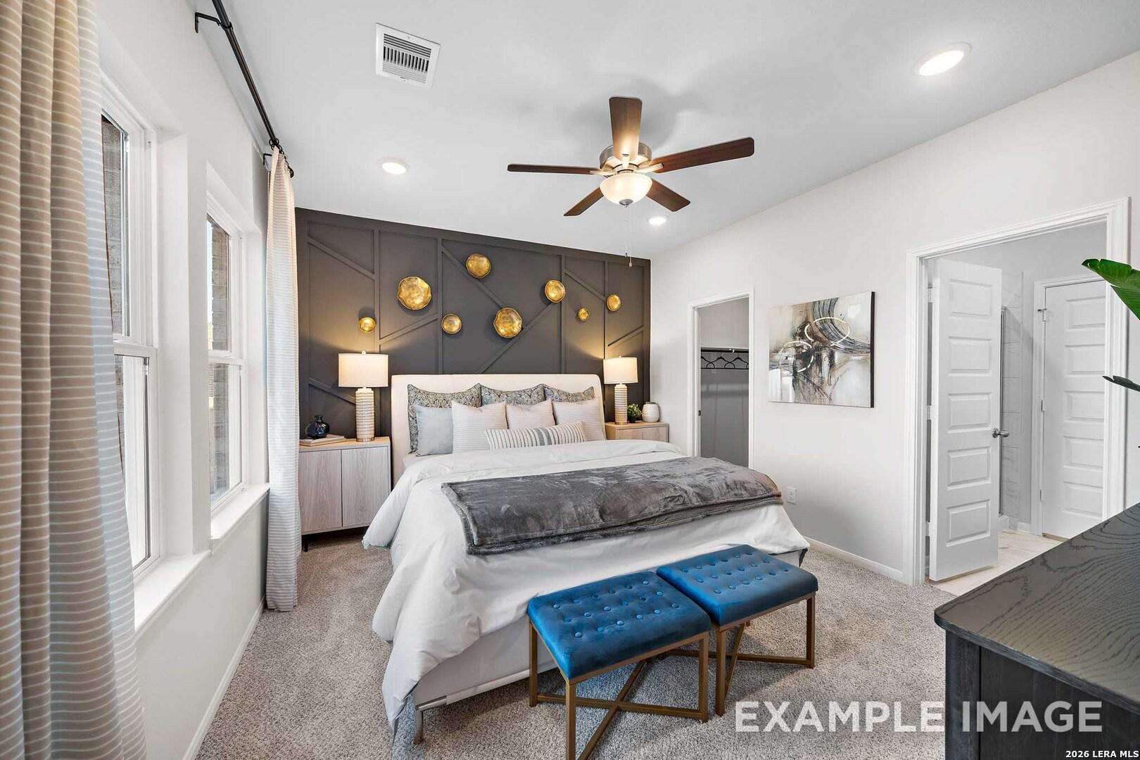 Primary bedroom with charcoal accent wall and gold decor in The San Marcos F floor plan by Davidson Homes, San Antonio.