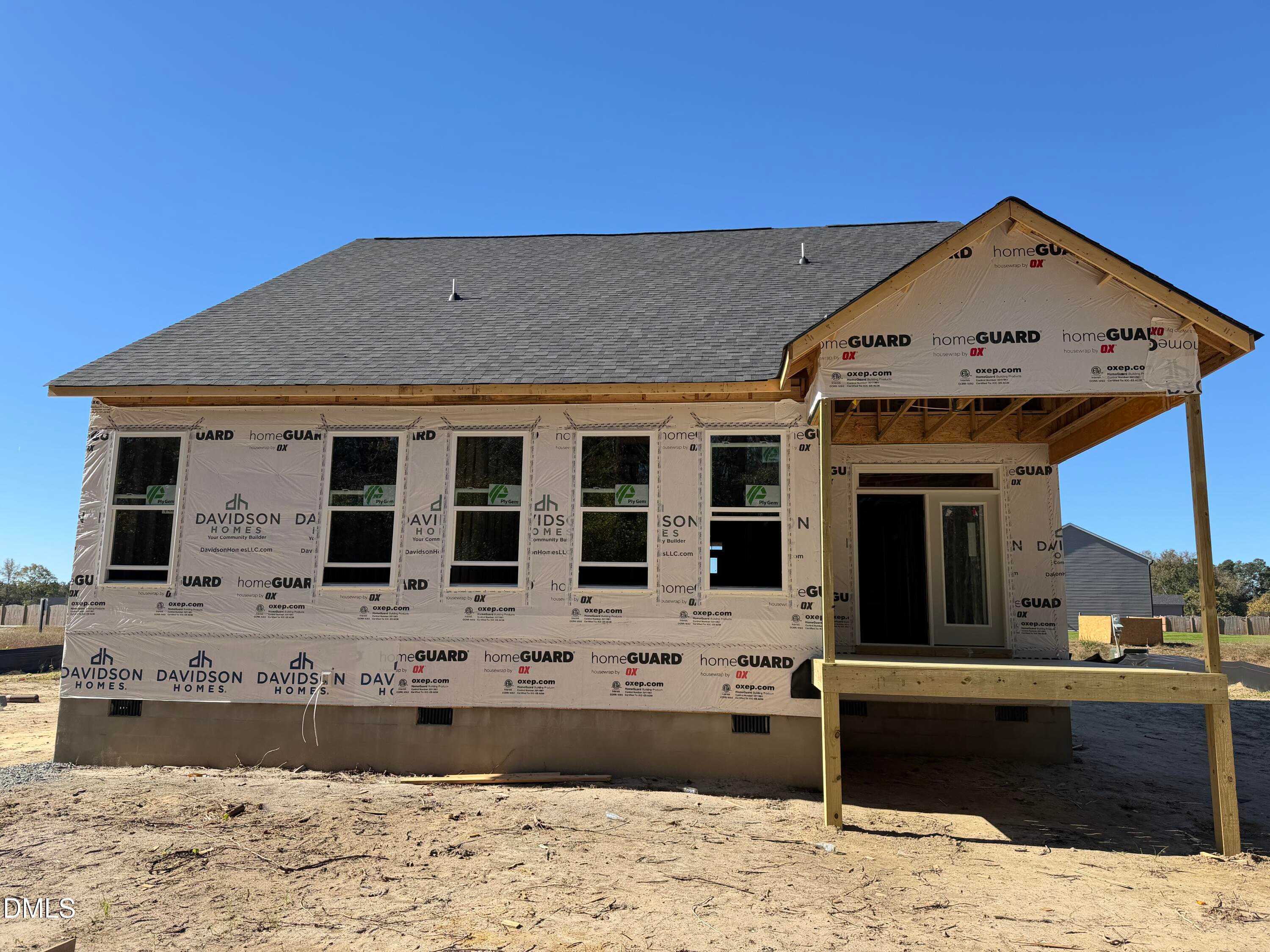 New construction two-story Davidson Homes The Ash B exterior with house wrap, windows, and front porch in Wellers Knoll, Lillington, NC