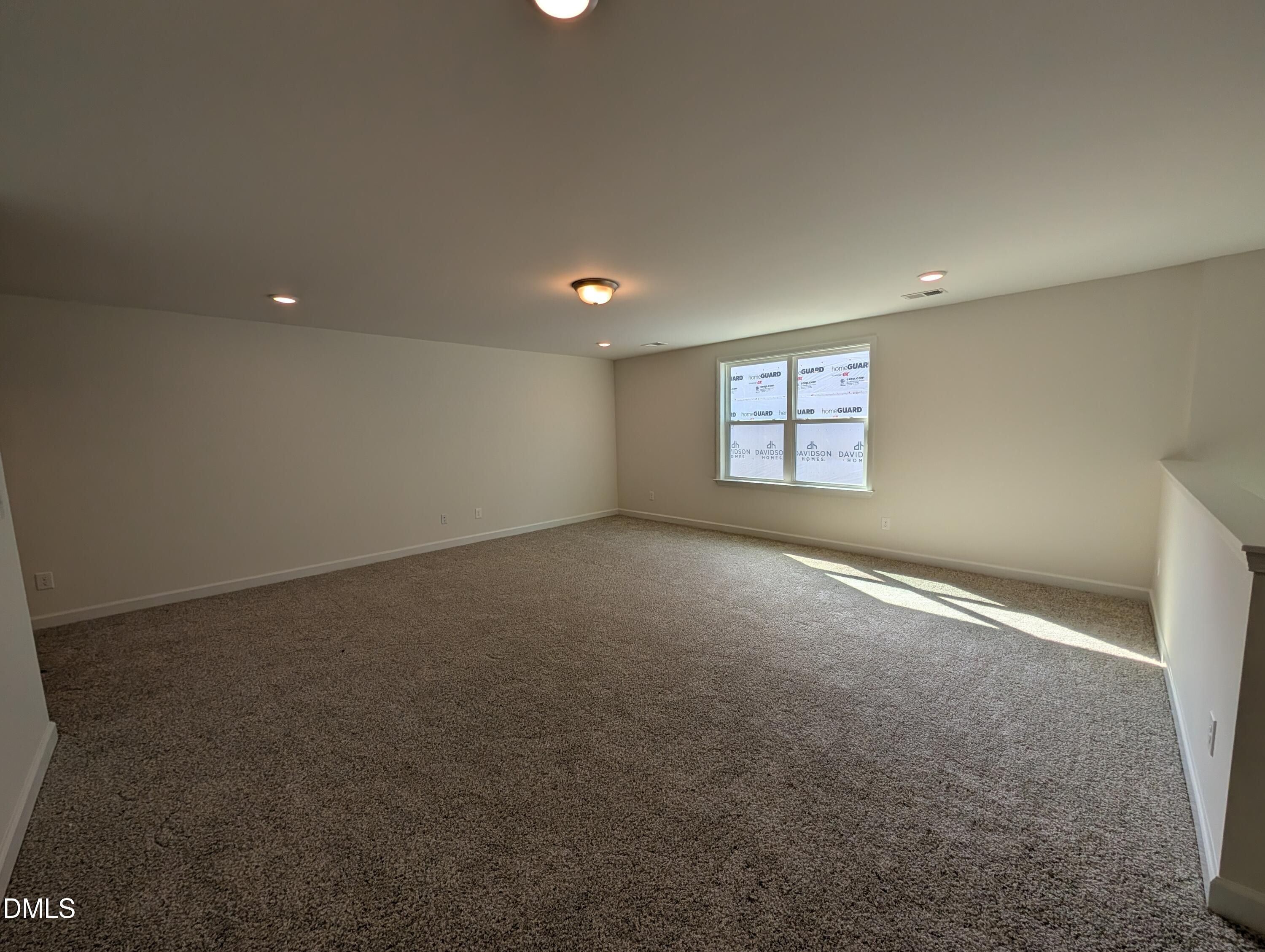 Spacious carpeted bonus room with natural light in Davidson Homes The Magnolia A, Wendell Ridge, North Carolina