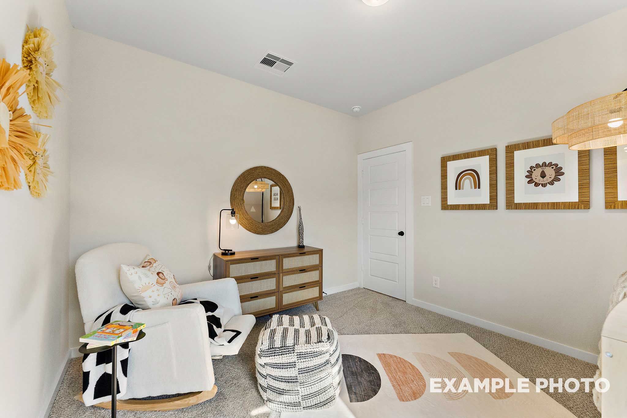 Boho-style nursery with white rocking chair and wicker decor in The Everett E floor plan at Sundance Cove, Crosby, Texas.