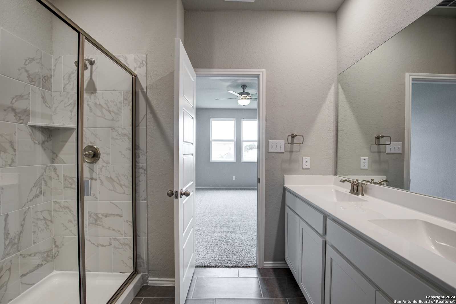 Modern master bathroom with frameless glass shower, subway tile, double vanity in Davidson Homes The Daphne J, Seguin, Texas