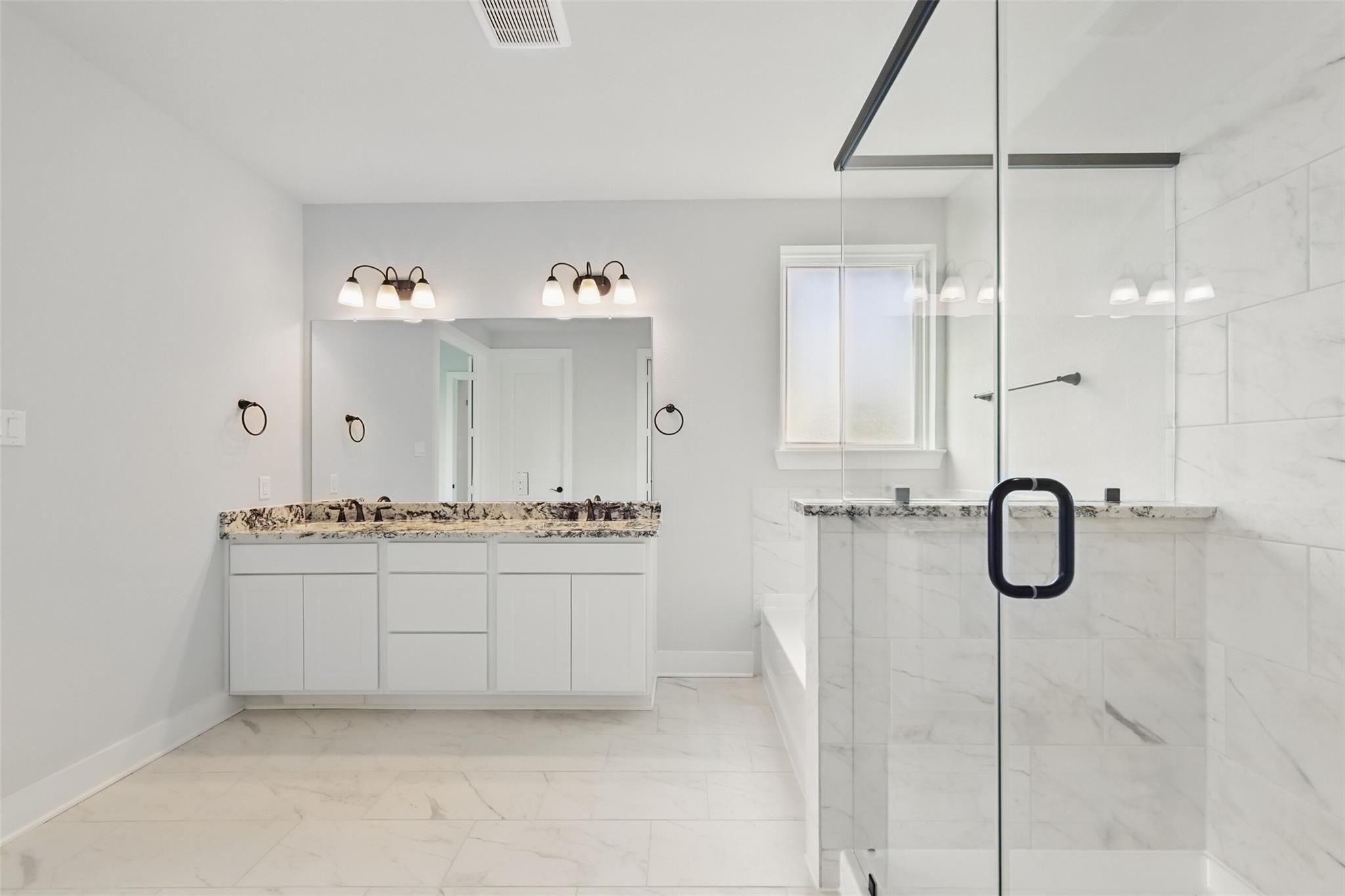 Modern master bathroom with dual vanities, frameless glass shower, soaking tub in Davidson Homes The Victoria C, Lago Mar, Texas City