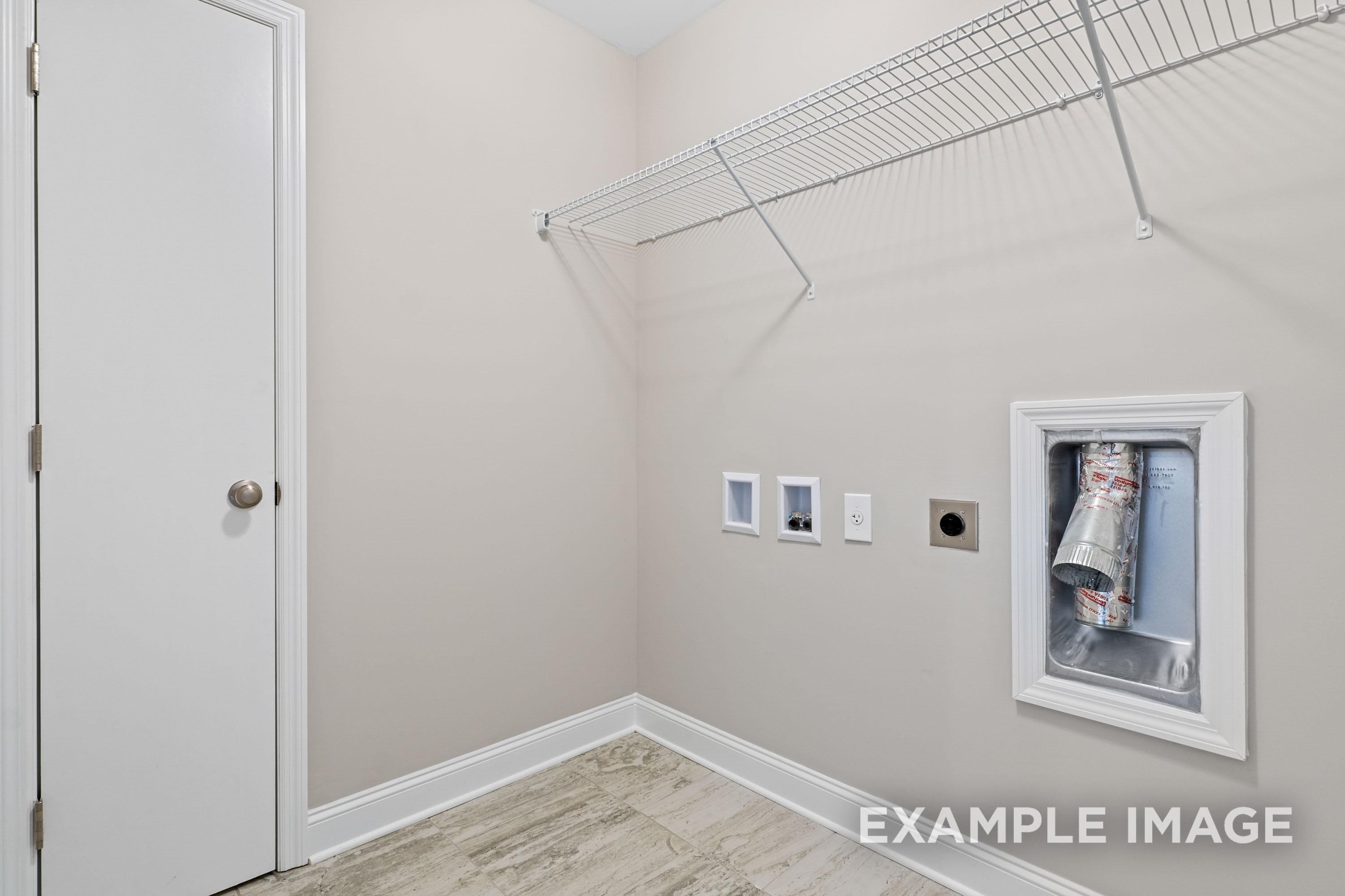 The Madison B laundry room featuring wire shelving, washer dryer hookups, and neutral beige walls in Davidson Homes design