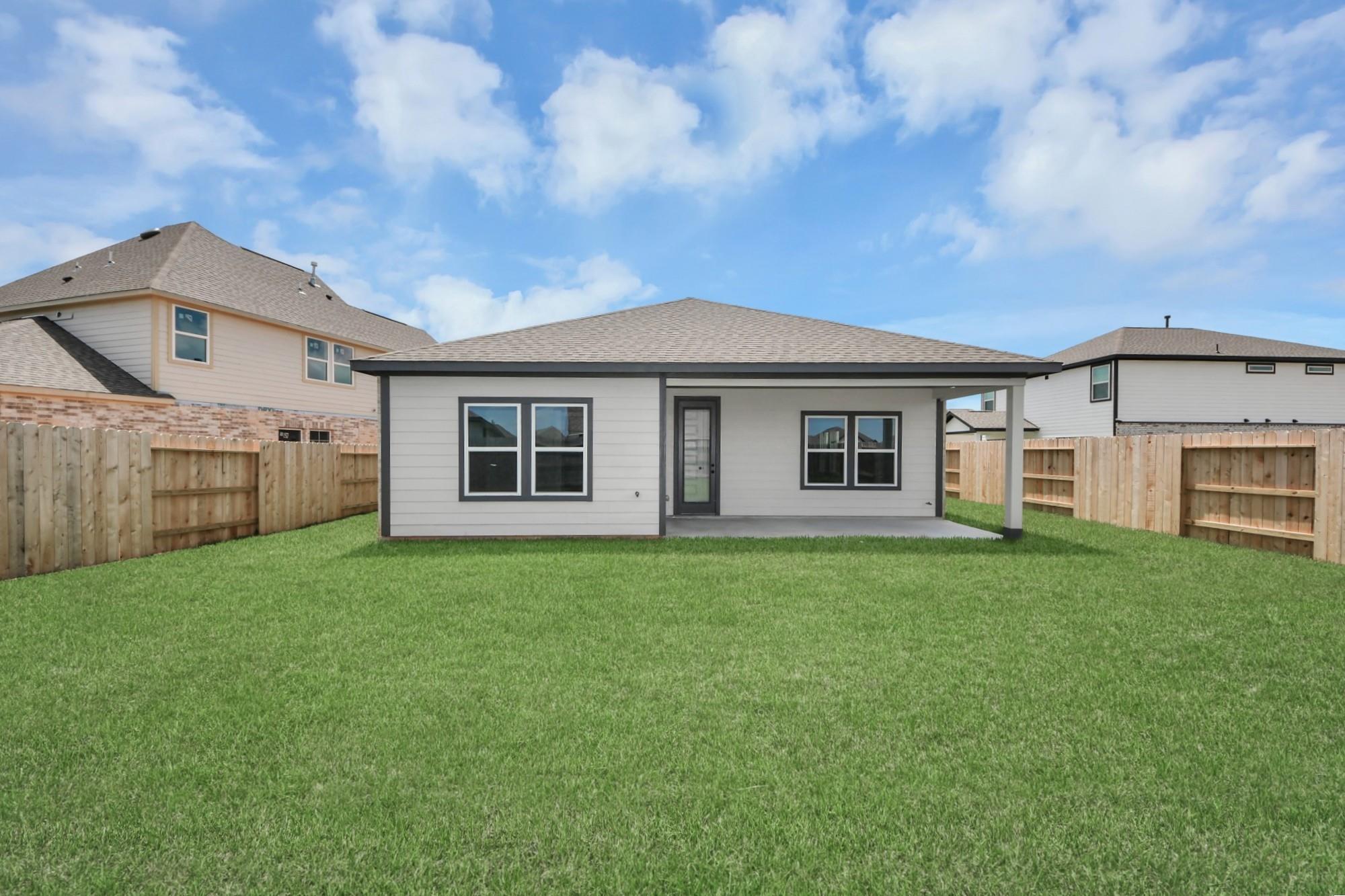 Private backyard and covered patio of The Laguna C floor plan by Davidson Homes in Sunterra, Katy, Texas.