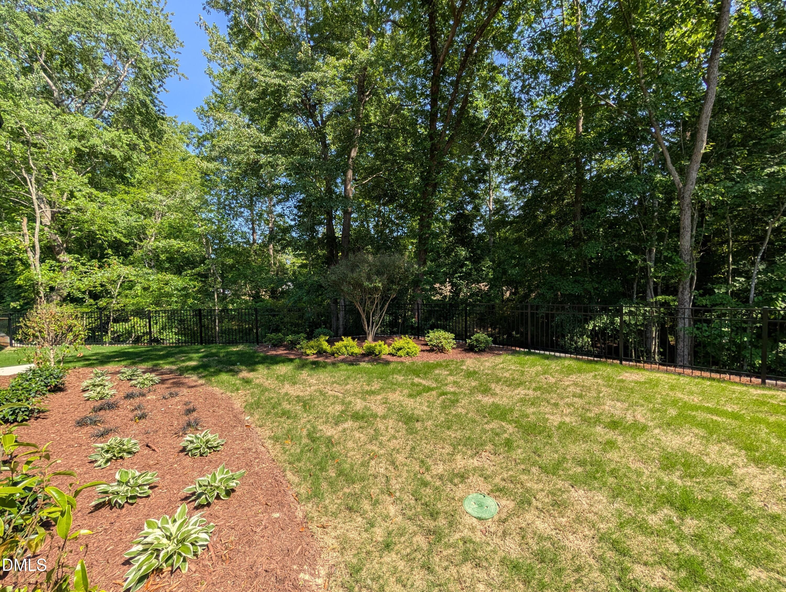 Private fenced backyard with lush landscaping in The Aspen B floor plan at Wendell Ridge in Wendell, North Carolina.