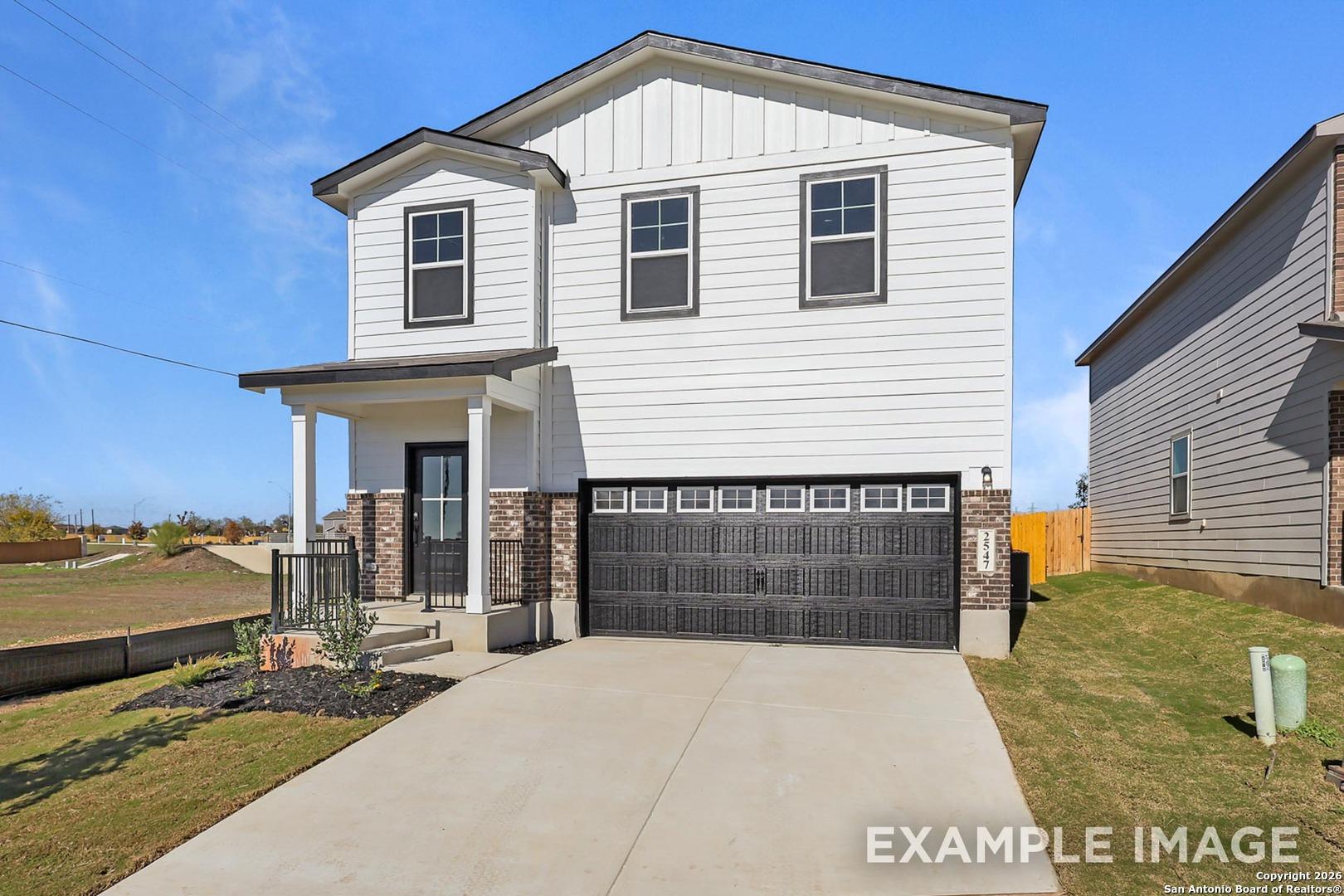 Modern two-story white home with black-trimmed two-car garage and front porch in Applewhite Meadows, San Antonio, Texas - Davidson Homes The Trinity B