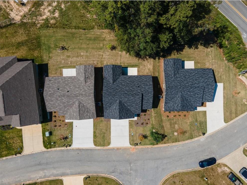 Aerial view of three single-story The Washington homes with garages and lawns in Summer Vineyard, Phenix City, Alabama