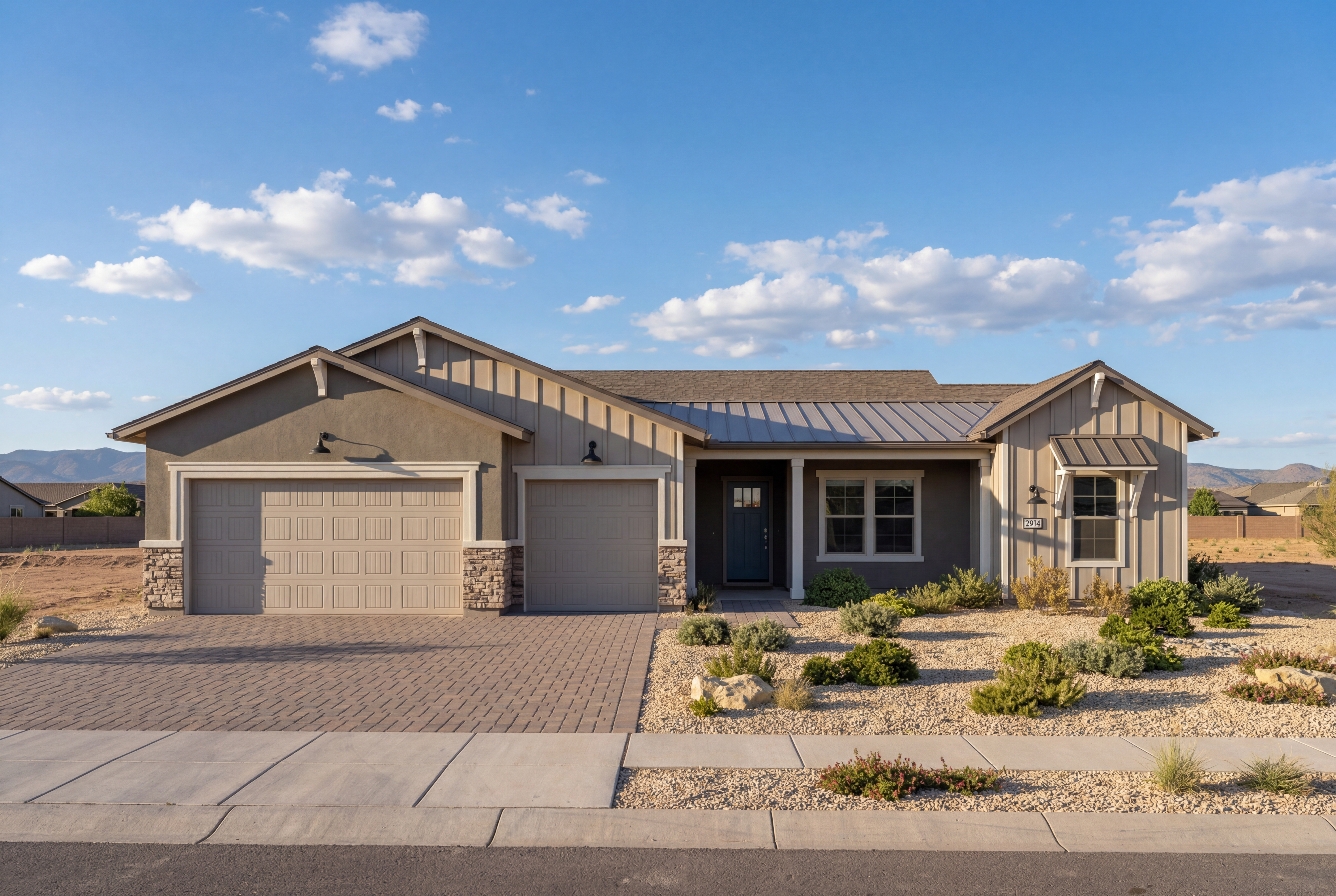 Modern farmhouse elevation of The Blaze E with a 3-car garage, stone accents, and desert landscaping in Prescott, Arizona.
