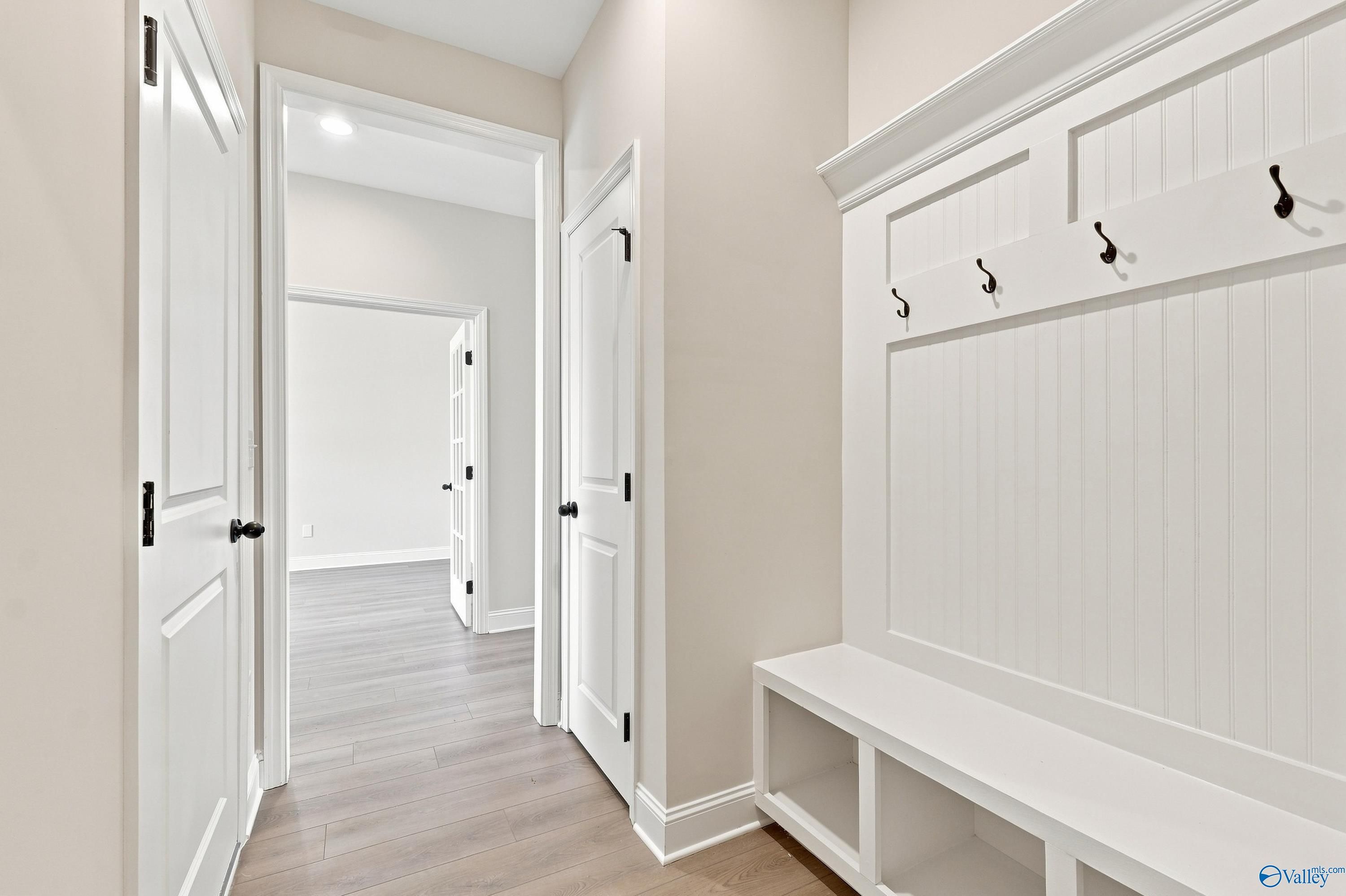 Built-in mudroom bench with coat hooks in The Rockford B floor plan at Kendall Downs in Toney, Alabama.