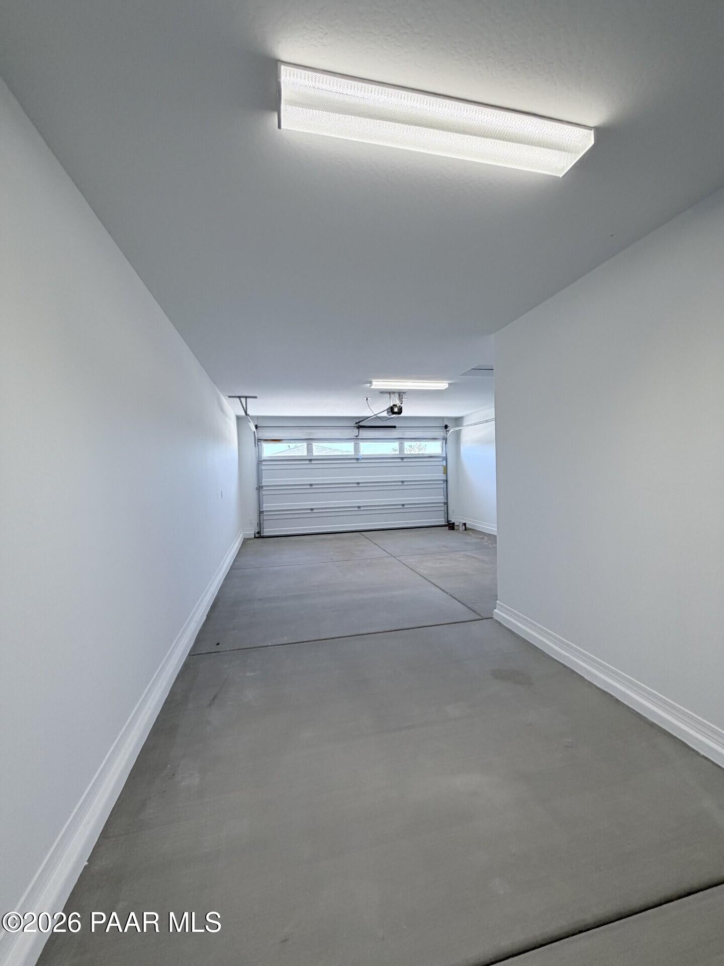 Spacious 3-car garage with overhead lighting in The Frontier A floor plan at North Ridge, Pronghorn Ranch, Prescott Valley.
