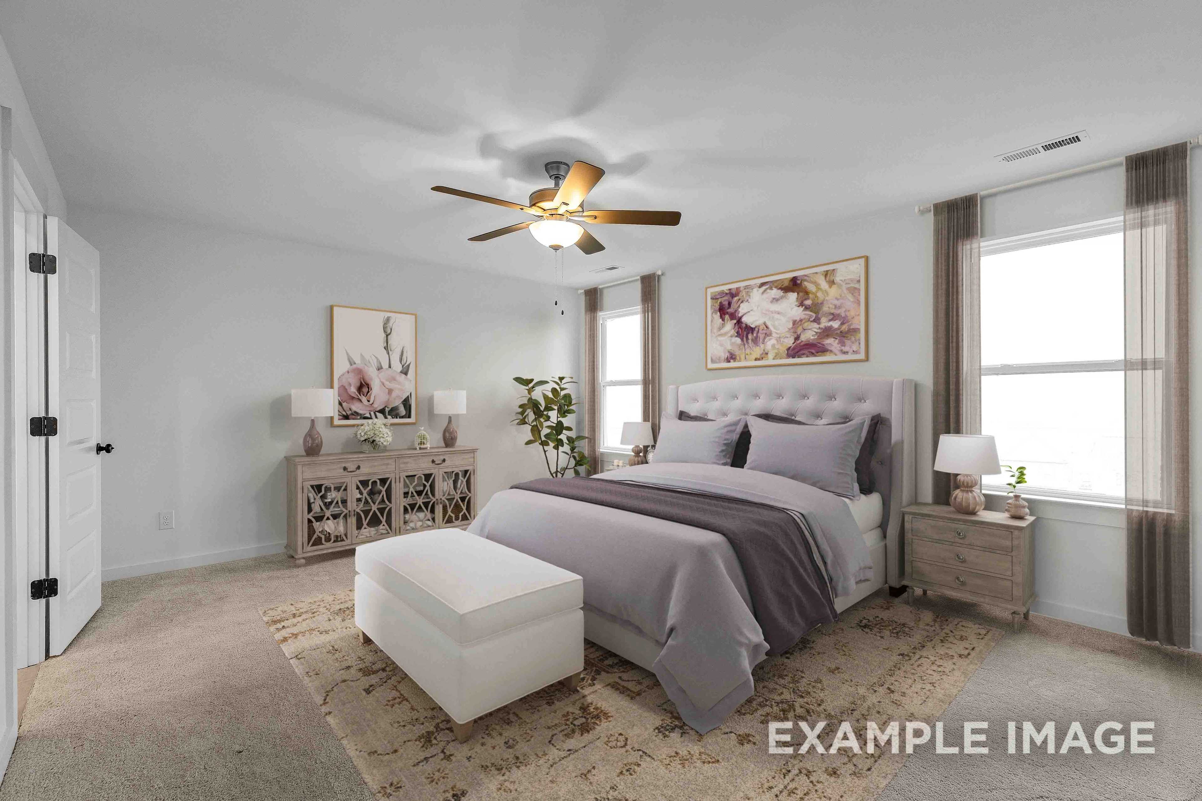The Charleston master bedroom: king bed with plush purple bedding, nightstands, lamps, ceiling fan, large windows