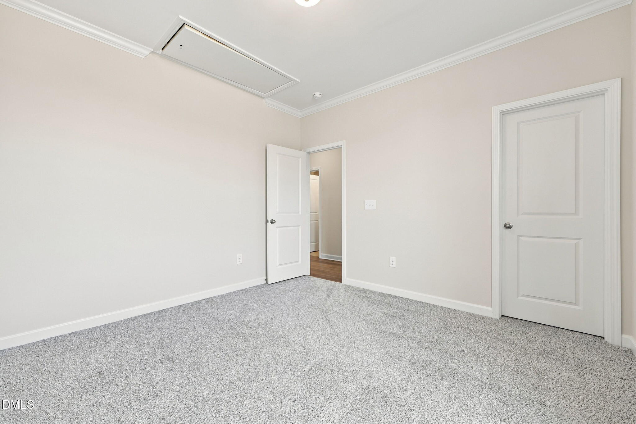 Spacious bedroom with neutral carpet in The Magnolia B floor plan at Retreat at North Main, Lillington, North Carolina.
