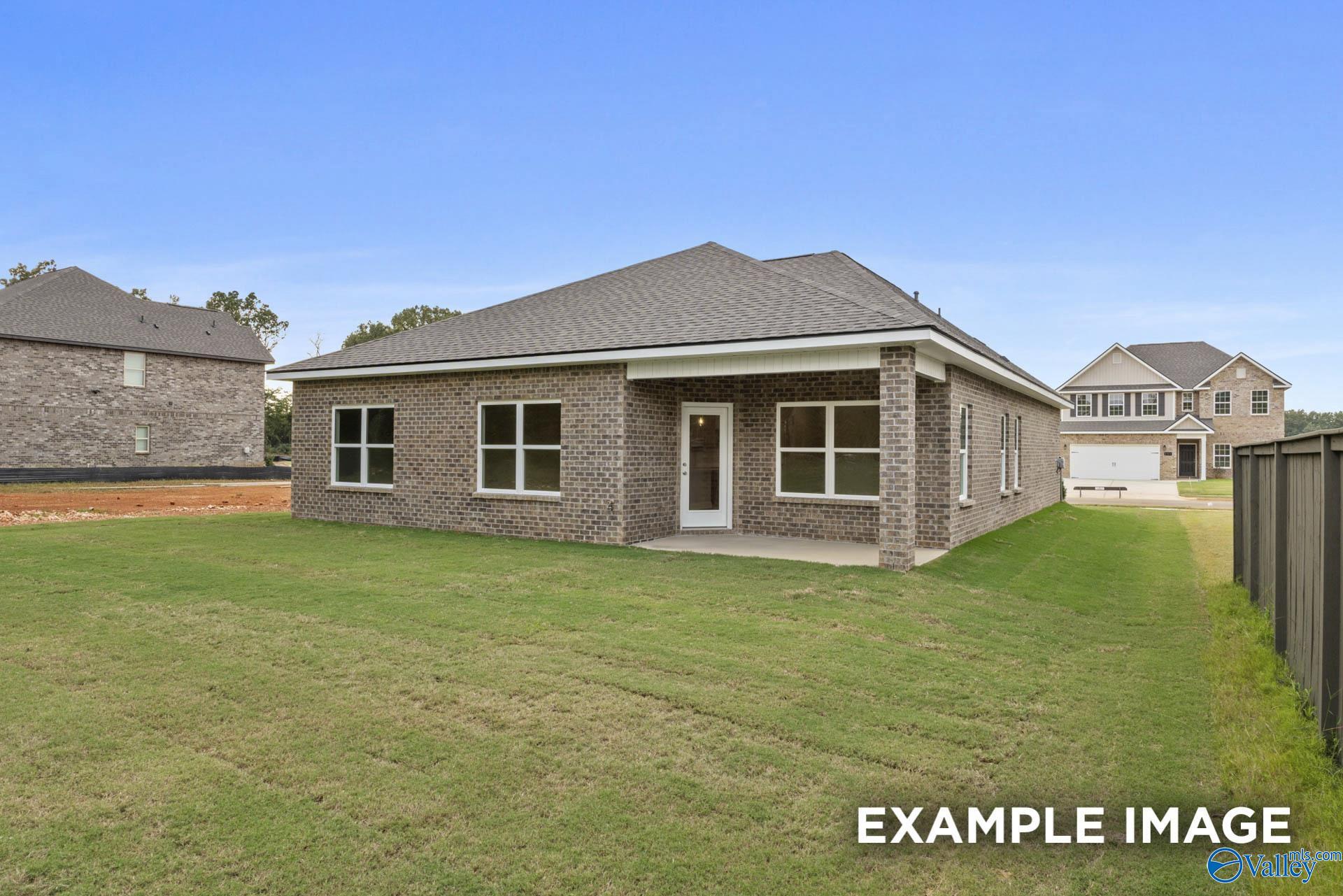 Rear exterior view of The Franklin C floor plan by Davidson Homes in Noble Ridge, Cullman, Alabama with a private backyard.