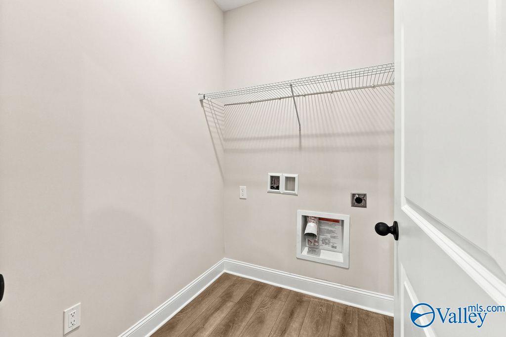 Laundry room with wire shelving and utility hookups in The Camilla C floor plan at The Retreat at Cain Park, Hartselle.