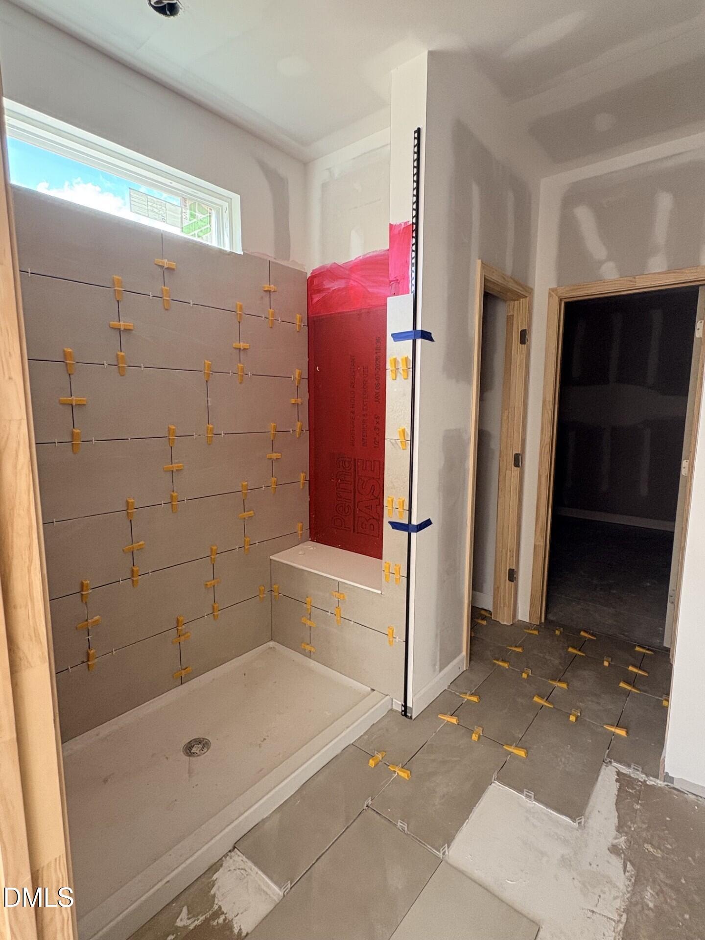 Walk-in shower tile installation with PermaBase backer board in The Ash C floor plan at Woodland Crossing, Zebulon, NC.