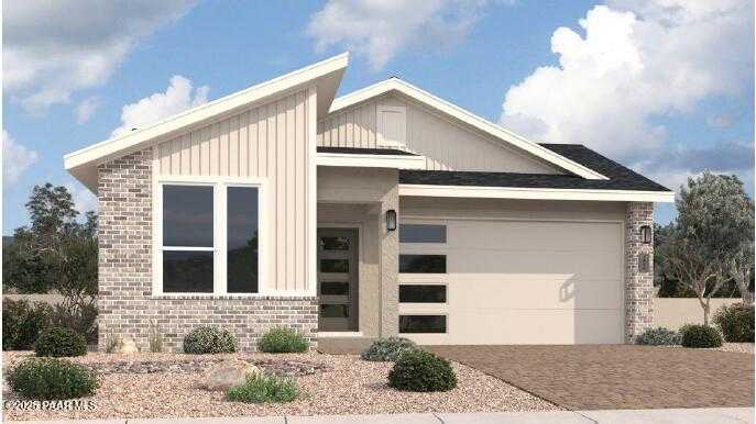 Modern Nantucket C single-story home exterior with 3-car garage, large windows, brick accents, and desert landscaping in Prescott, Arizona