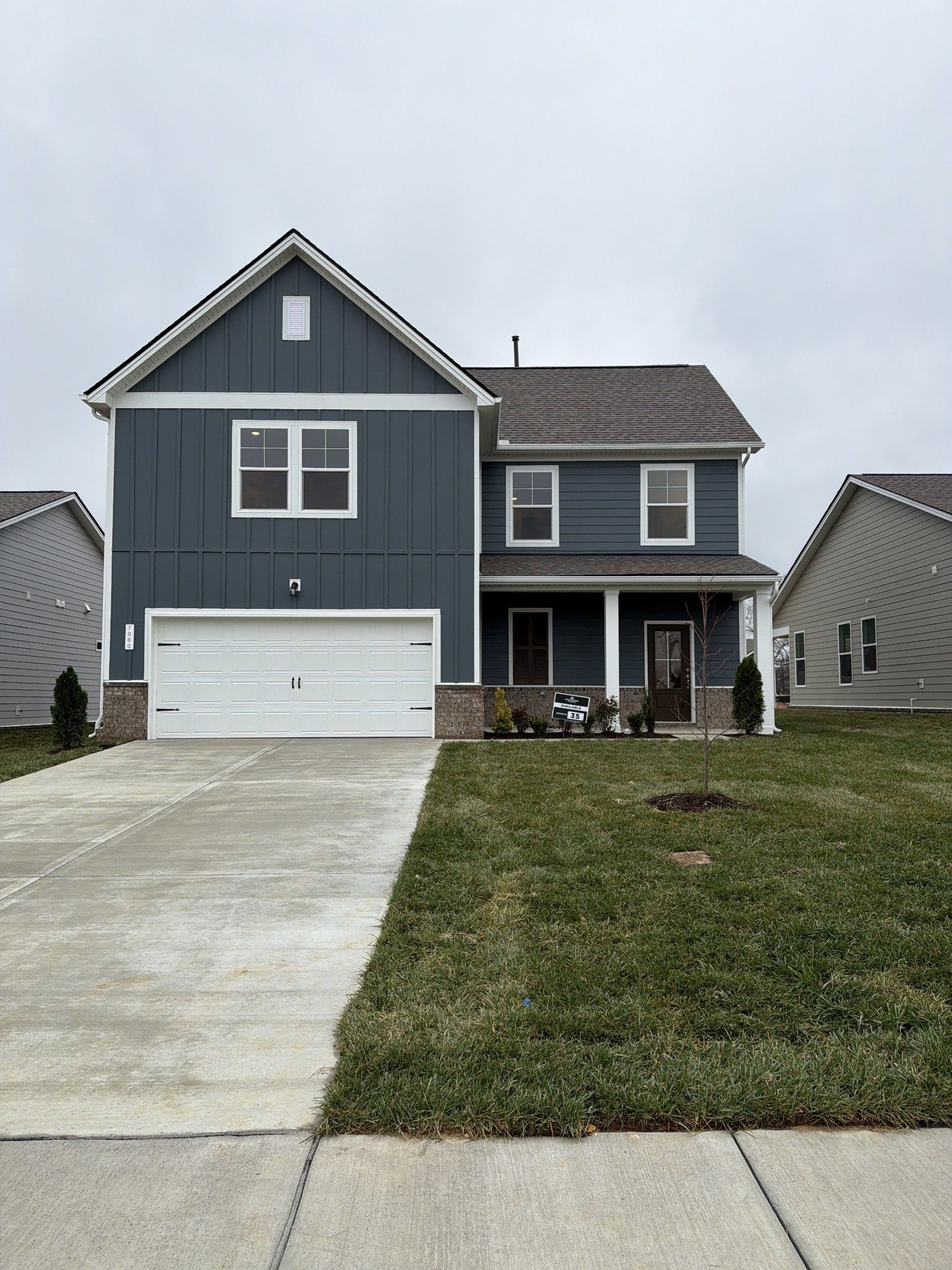 Two-story Davidson Homes Gordon B with 2-car garage, front porch, and manicured lawn in Sage Farms, White House, TN