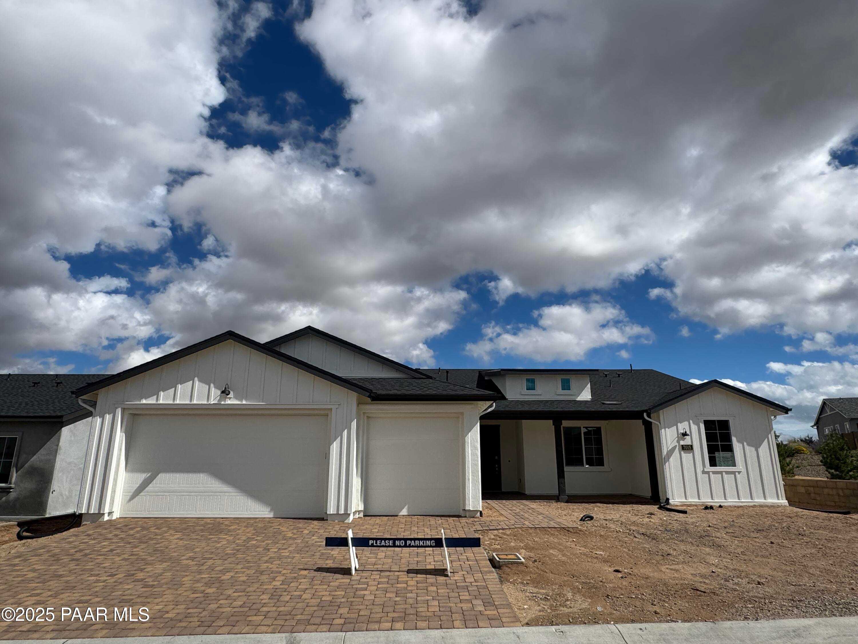 Modern white single-story home with 3-car garage and black trim, The Monarch E by Davidson Homes in Westwood, Prescott, Arizona
