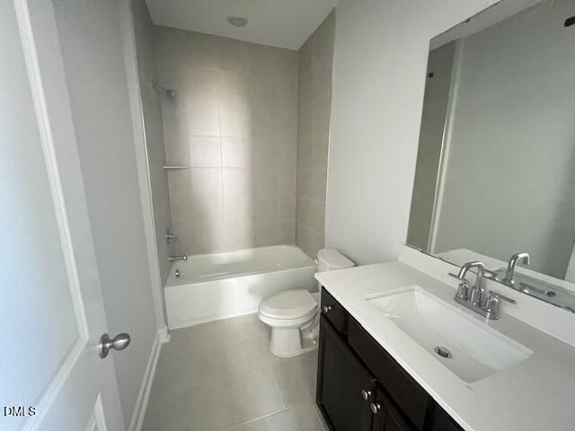Modern bathroom with white bathtub, shower, dark wood vanity, and large mirror in 4-bedroom Davidson Homes Adalynn A, Lillington, NC