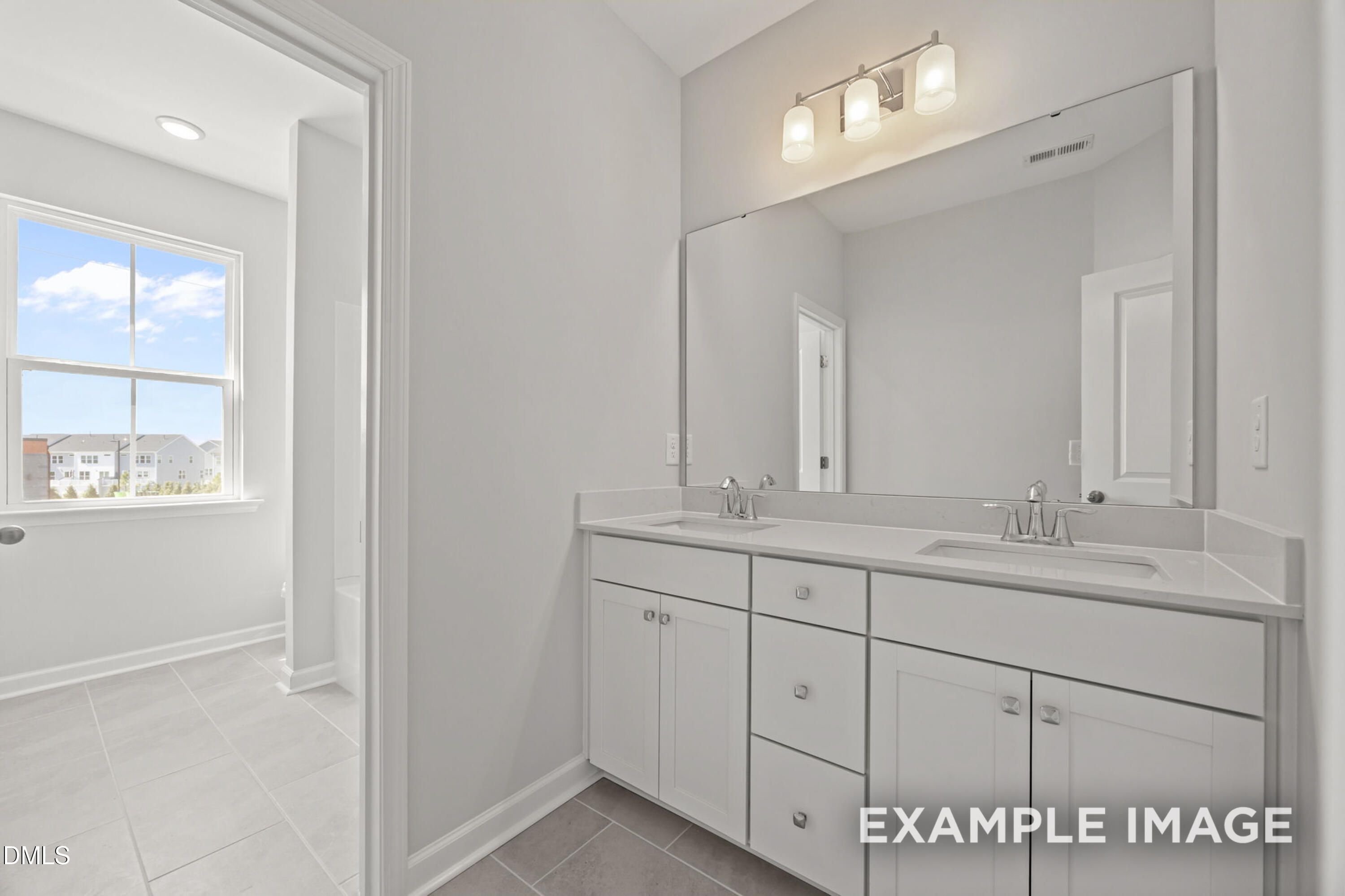 Modern bathroom with double vanity and large mirror in The Alexander B floor plan at Forestville Yard, Knightdale, NC.