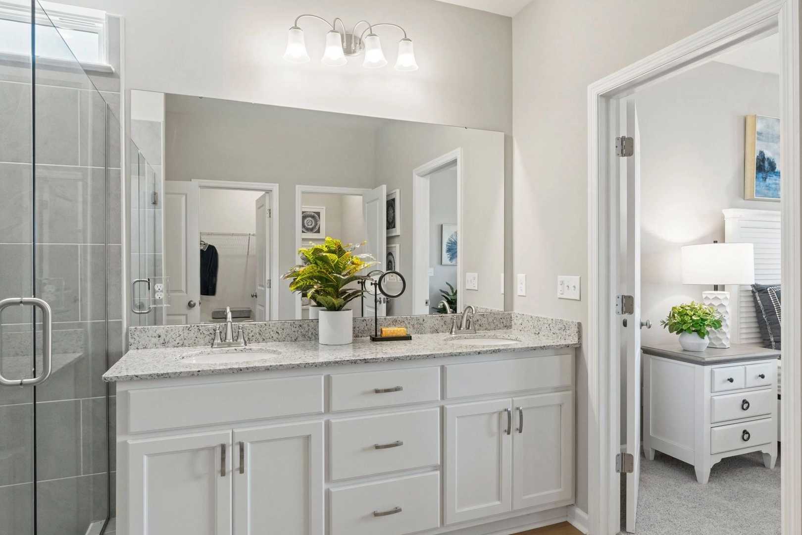 Spacious master bathroom at Bailey Park in Fayetteville TN with double vanity, granite counters and glass walk-in shower
