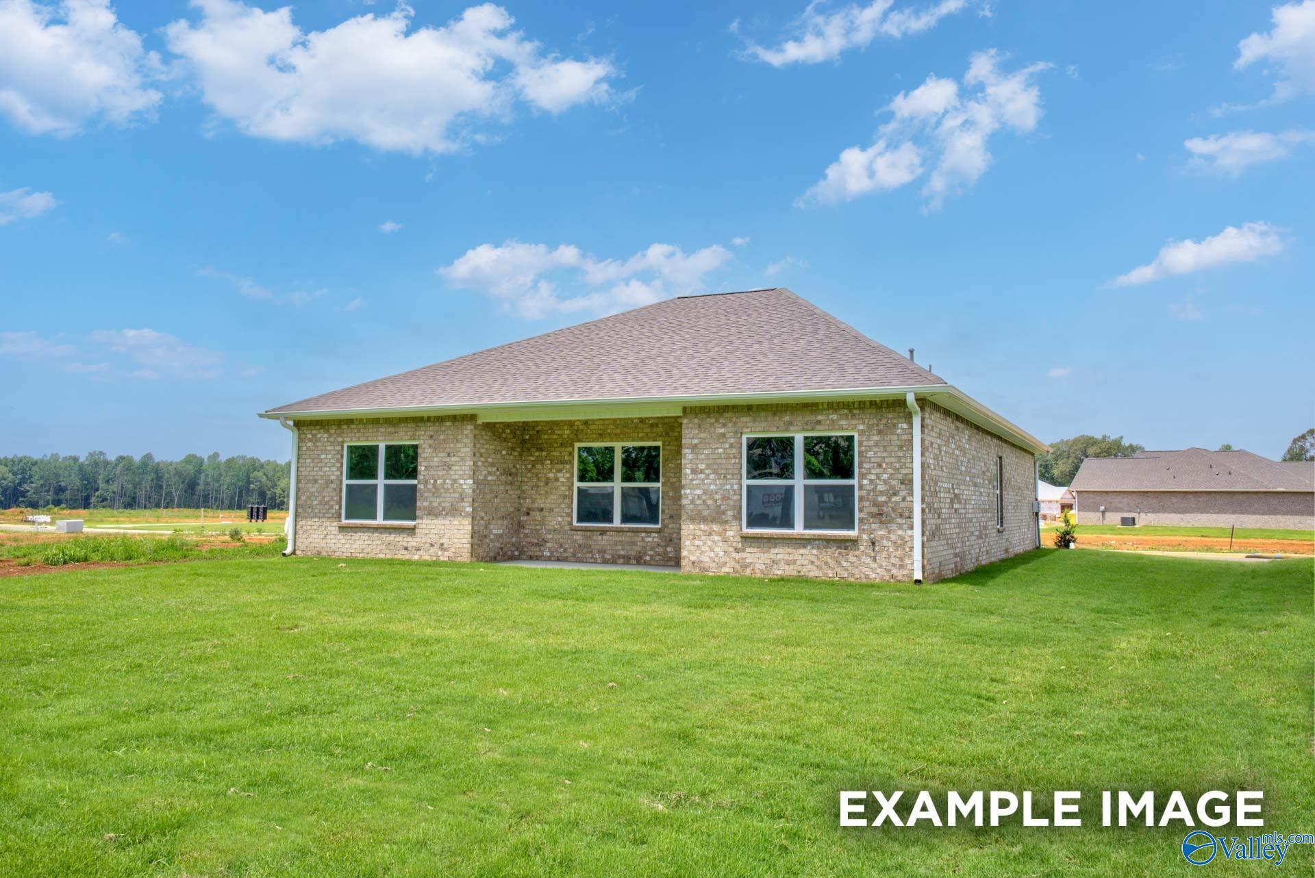 Single-story brick ranch home with shingled roof, large windows, and green lawn in Lynn Meadows, Meridianville, Alabama - The Asheville C by Davidson Homes