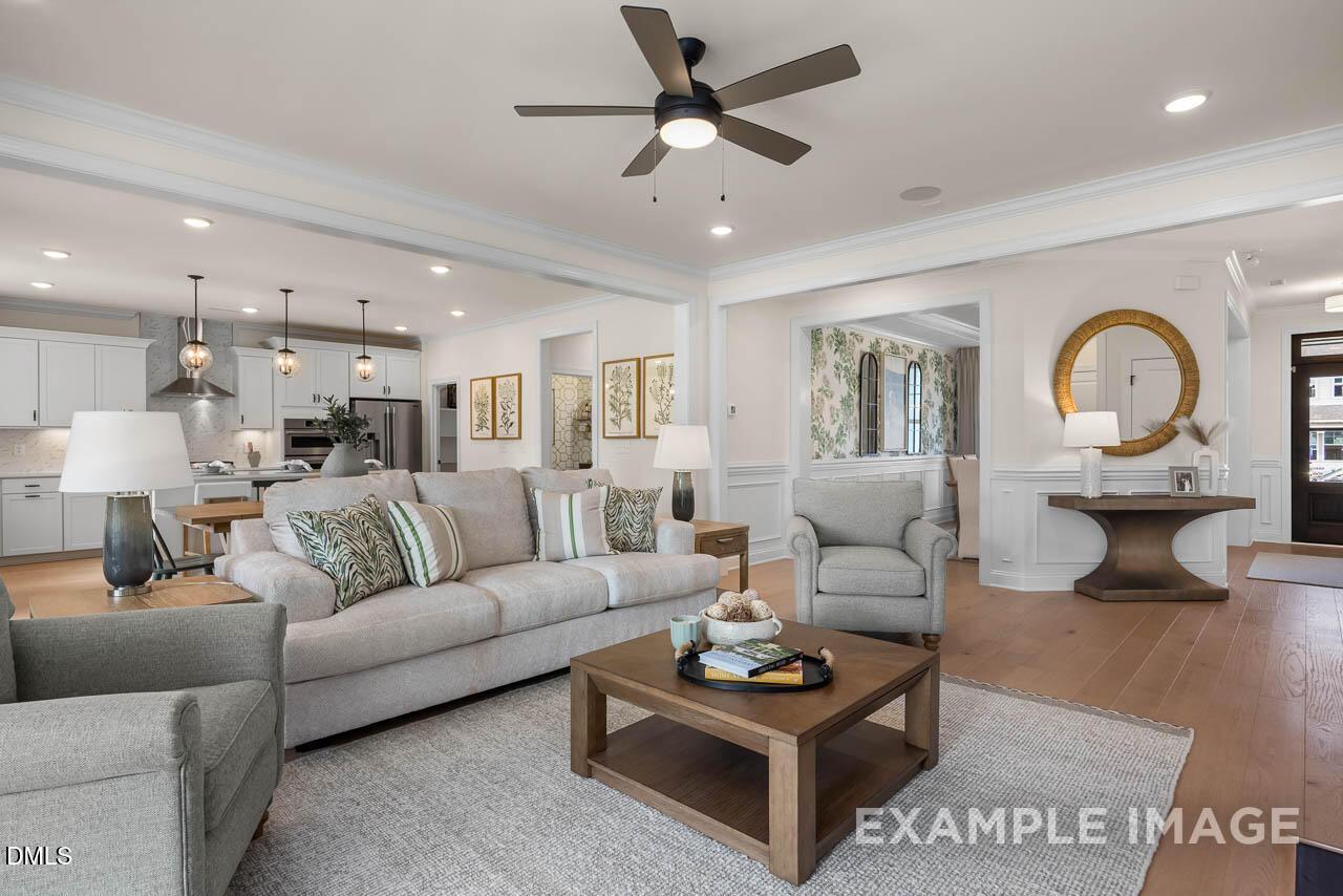 Open-concept living room with modern decor in The Crawford B floor plan at Addison West, Holly Springs, North Carolina.