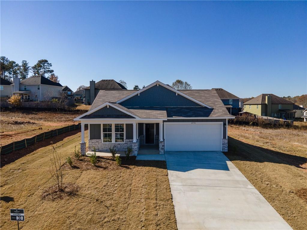Modern gray single-story 4-bedroom home with 2-car garage and stone accents in Anderson Lakes, Opelika, Alabama - Davidson Homes Luna B